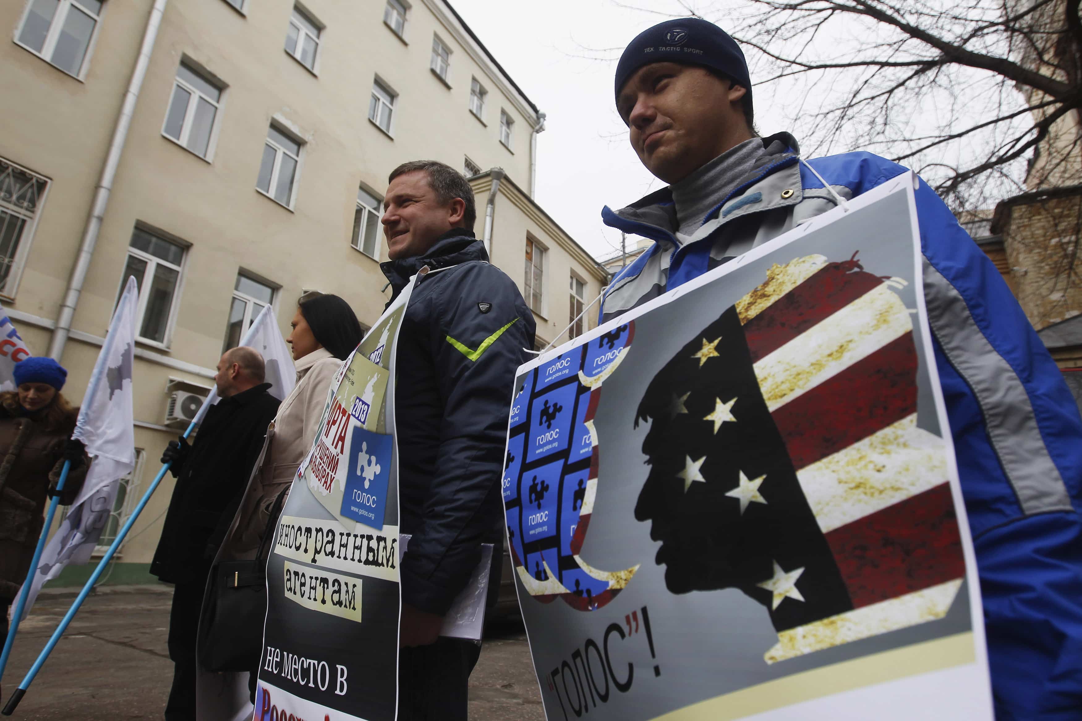 Activists stand outside the office of election monitoring non-governmental body Golos, during a protest against the organisation's foreign relations in Moscow, 5 April 2013, REUTERS/Maxim Shemetov