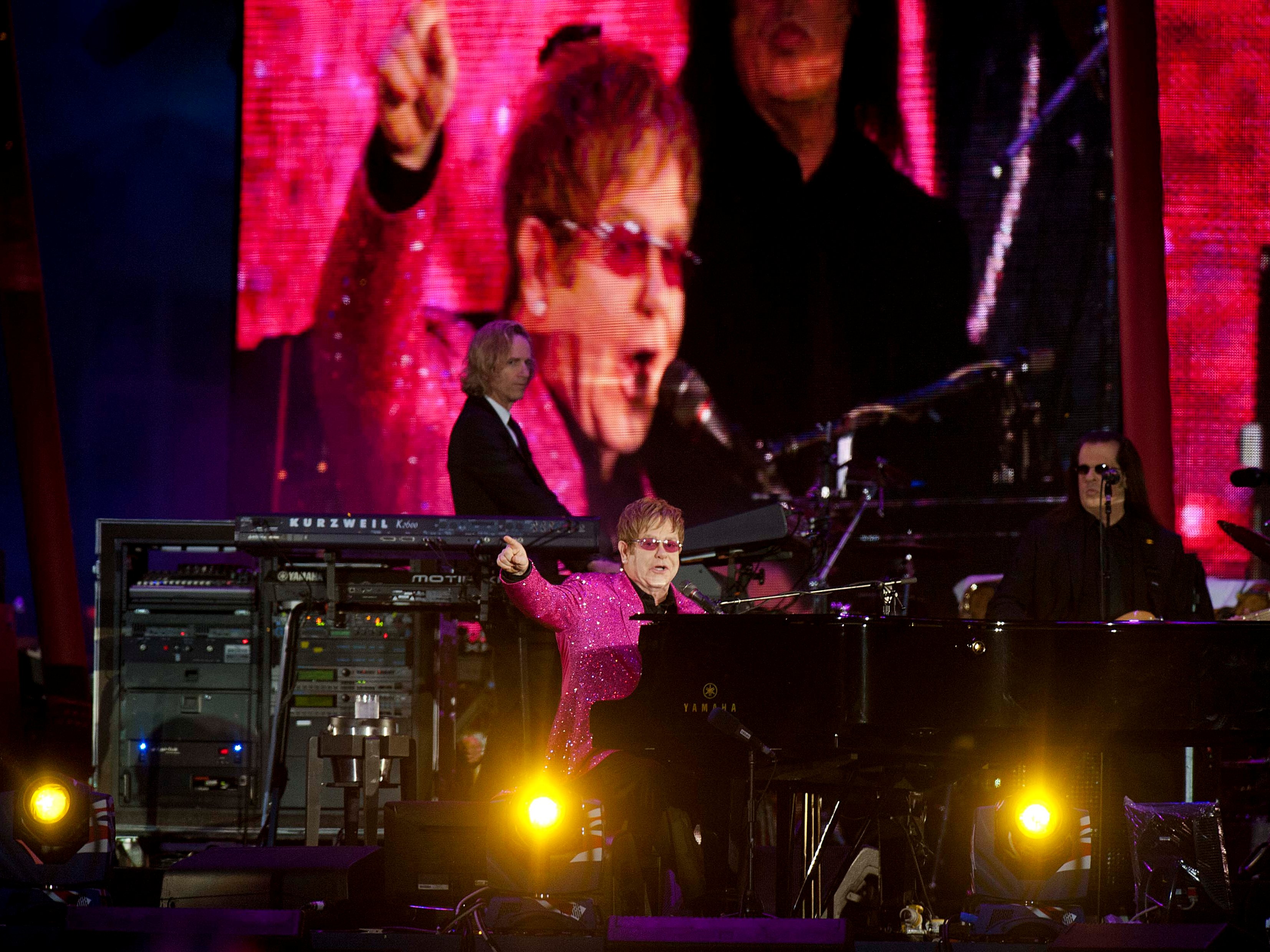 British singer Elton John performs in London, June 2012; the singer was warned that he may face prosecution if he performs in Russia because of the way he dresses onstage, REUTERS/David Parker/pool