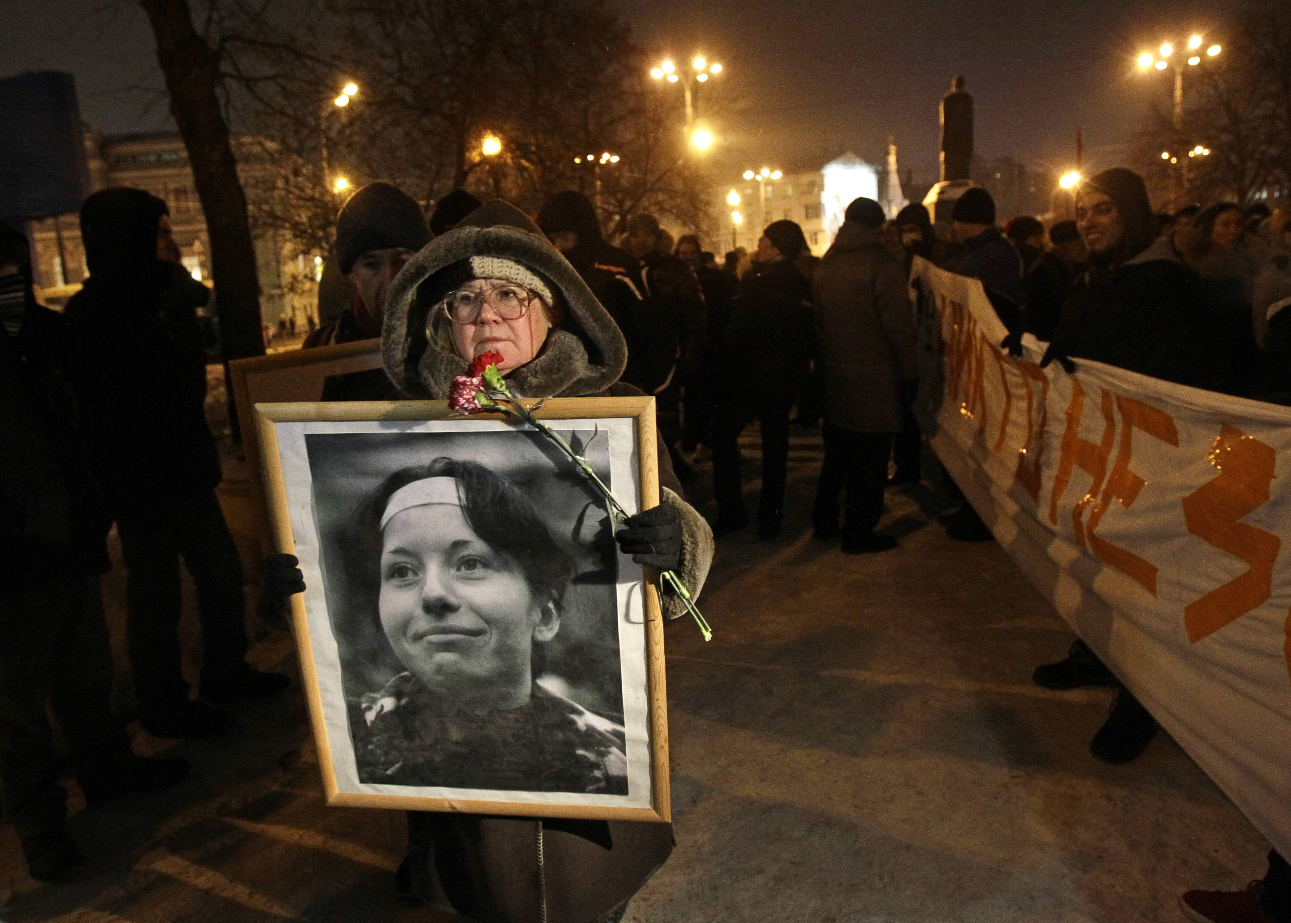 A demonstrator holds a portrait of slain reporter Anastasiya Baburova during a memorial rally in Moscow, 19 January 2011, AP Photo/Ivan Sekretarev