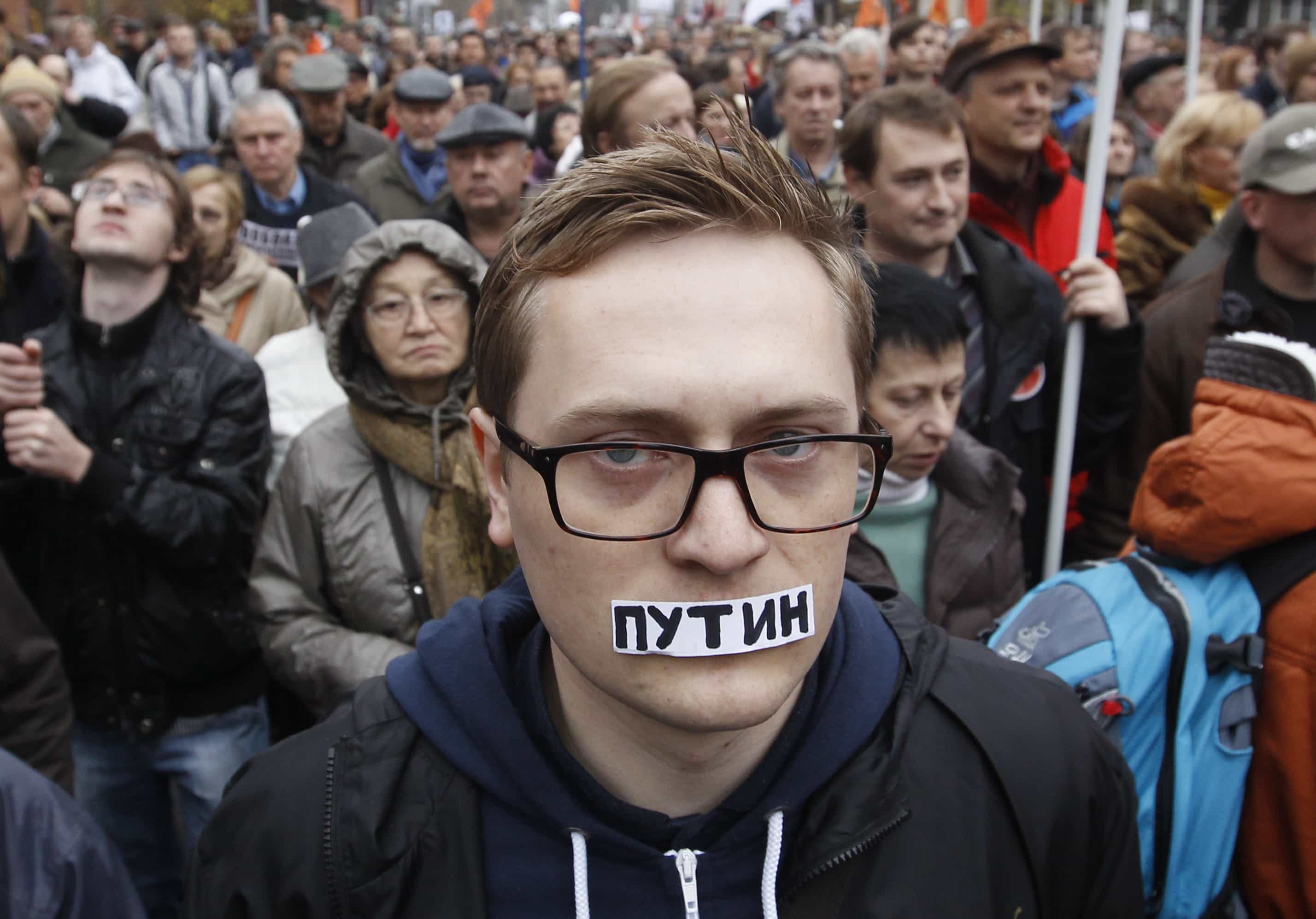 A man takes part in an opposition rally in Moscow, on 27 October 2013. Protesters demanded the release of political prisoners including anti-government activists detained in Moscow's Bolotnaya Square on May 6, 2012, the eve of President Vladimir Putin's inauguration. The sticker reads "Putin.", REUTERS/Maxim Shemetov