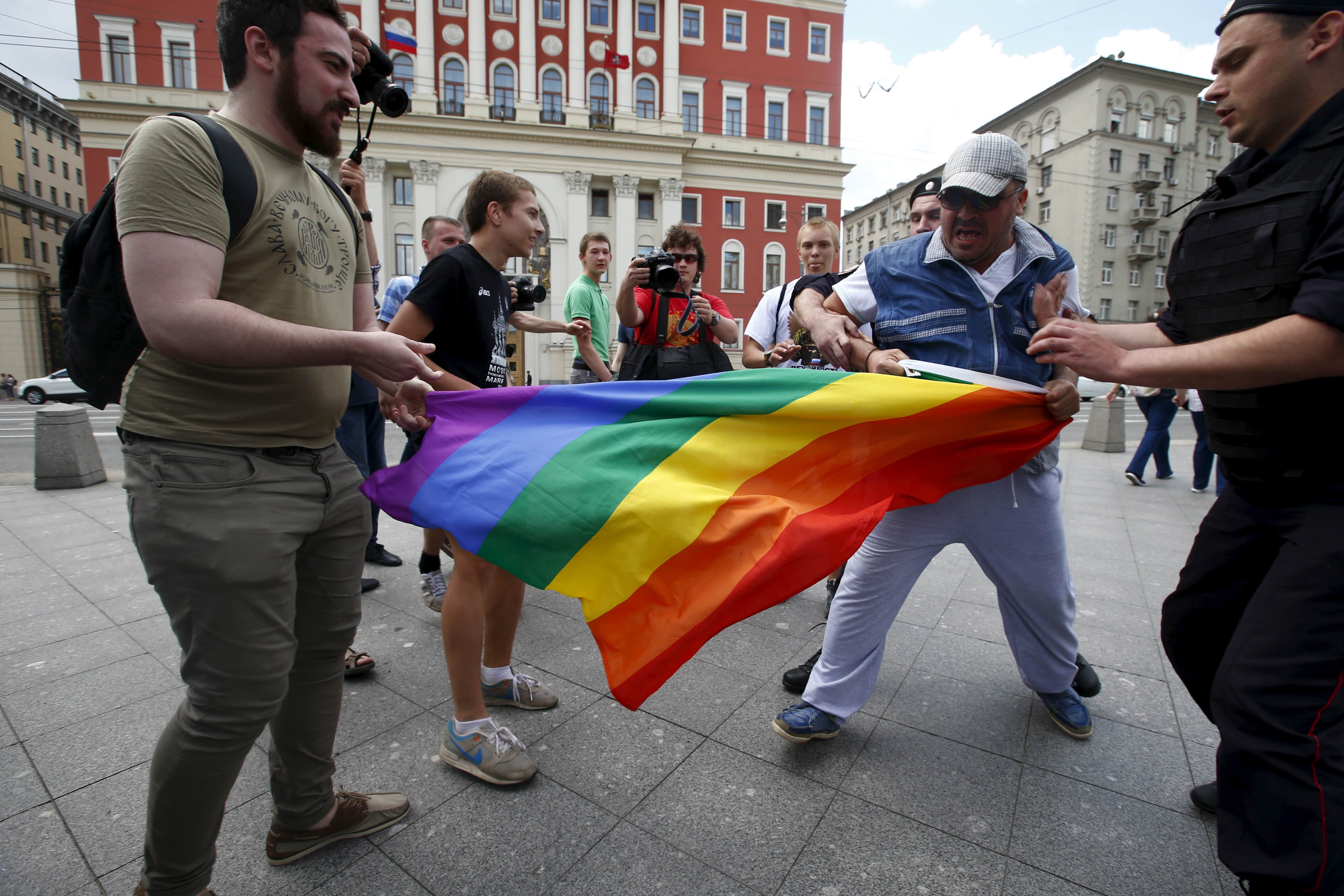 Anti-gay protesters try to tear a rainbow flag during an LGBT community rally in Moscow, 30 May 2015, REUTERS/Maxim Zmeyev