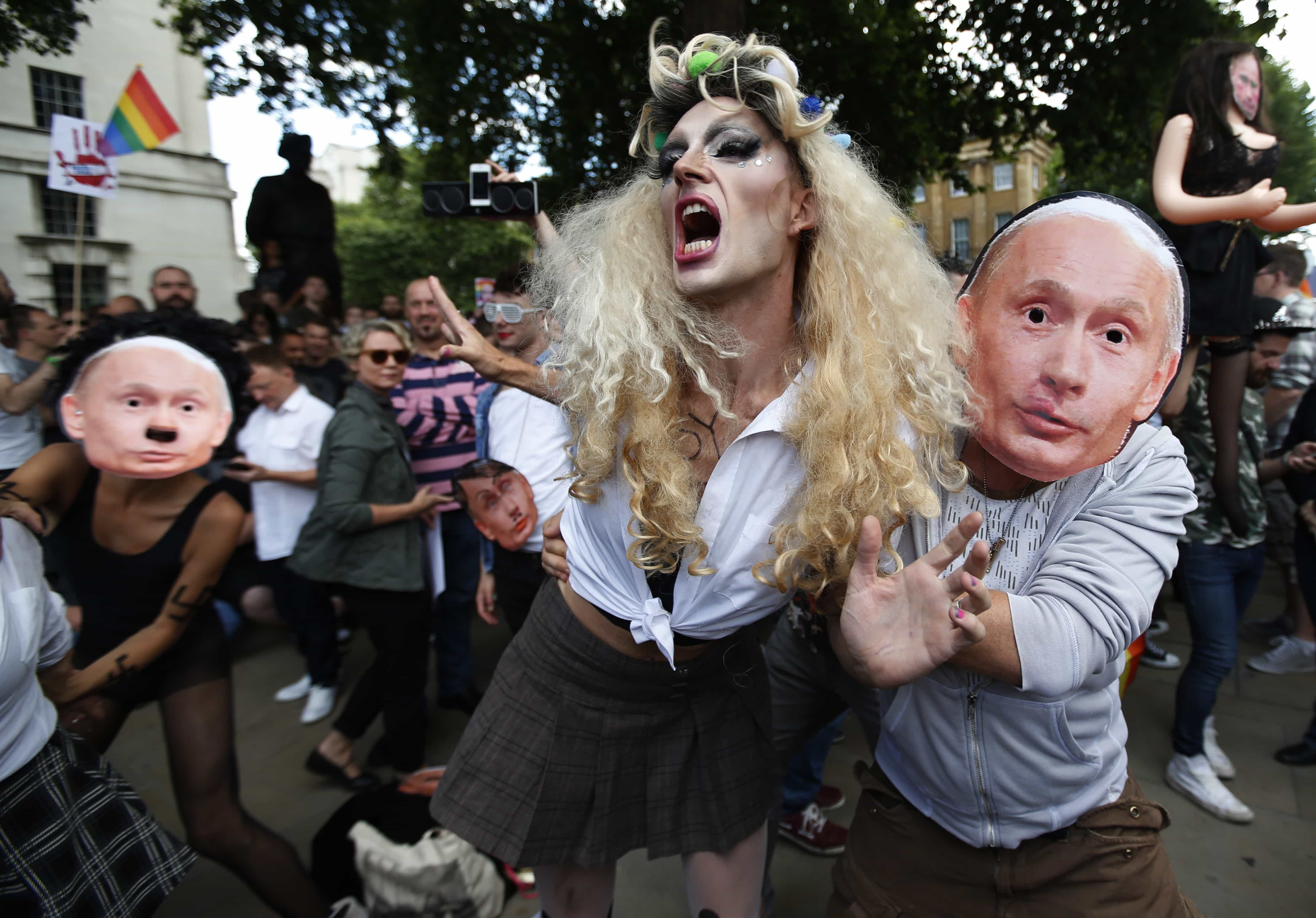 Activists stage a theatrical play where gay people are restrained by others wearing masks depicting Russian President Vladimir Putin, during a protest in London, 10 August 2013, AP Photo/Lefteris Pitarakis