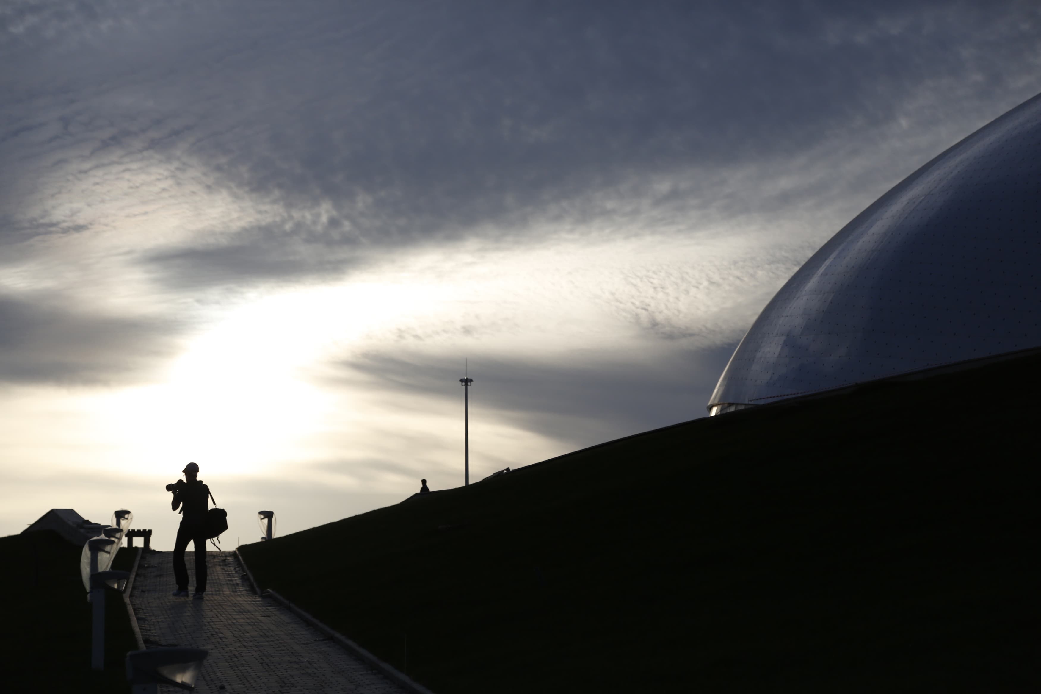 A photographer is seen near "Bolshoy" Ice Dome, part of the complex of facilities to be used for the Sochi 2014 Winter Olympics, 6 November 2012. , REUTERS/Pawel Kopczynski