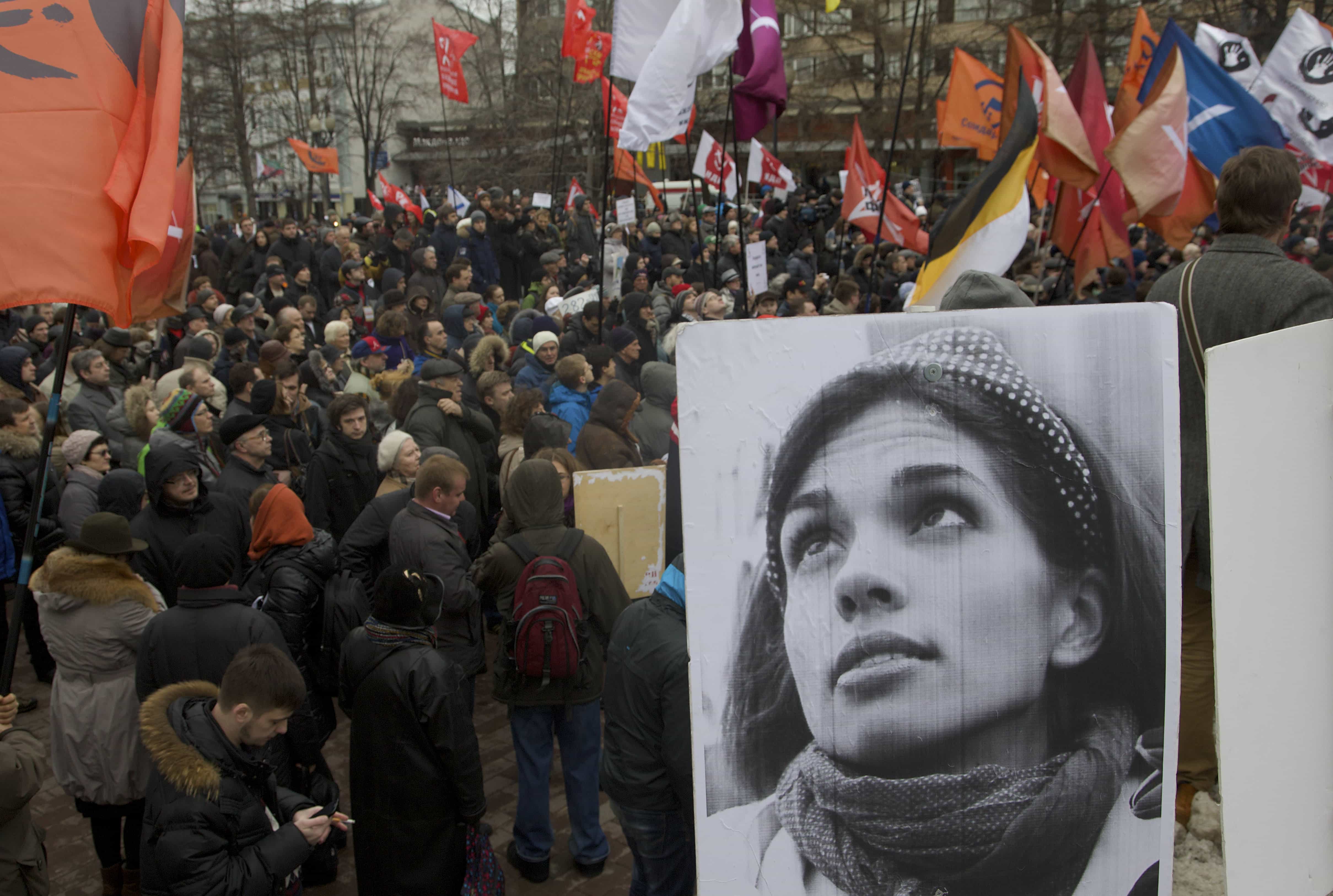 Demonstrators hold flags and a portrait, front, of jailed punk band Pussy Riot member Nadezhda Tolokonnikova, during an opposition rally in Moscow, 6 April 2013., AP Photo/Ivan Sekretarev