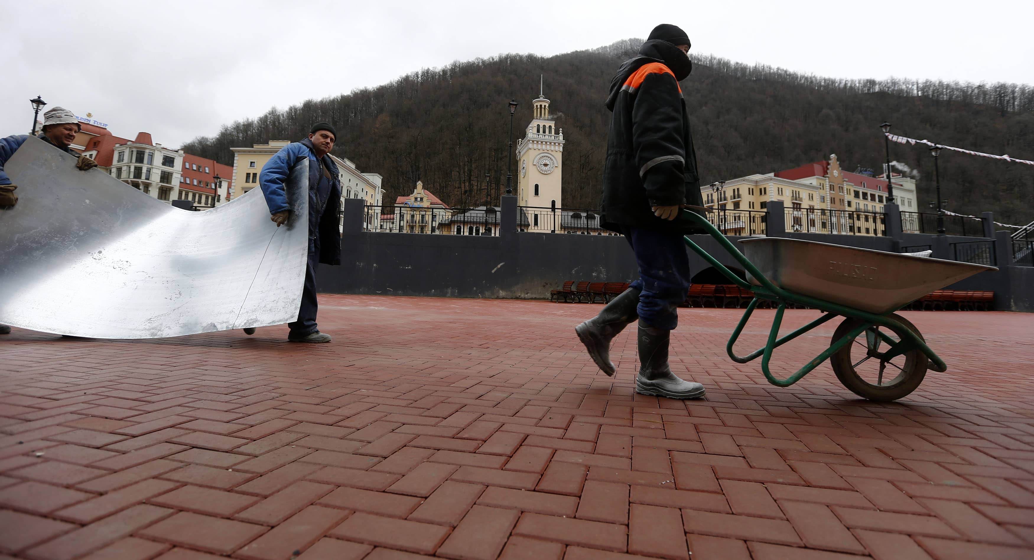 Construction workers are seen in the streets of the winter sport resort of Rosa Khutor, a venue for the Sochi 2014 Winter Olympics, February 2013. , REUTERS/Kai Pfaffenbach