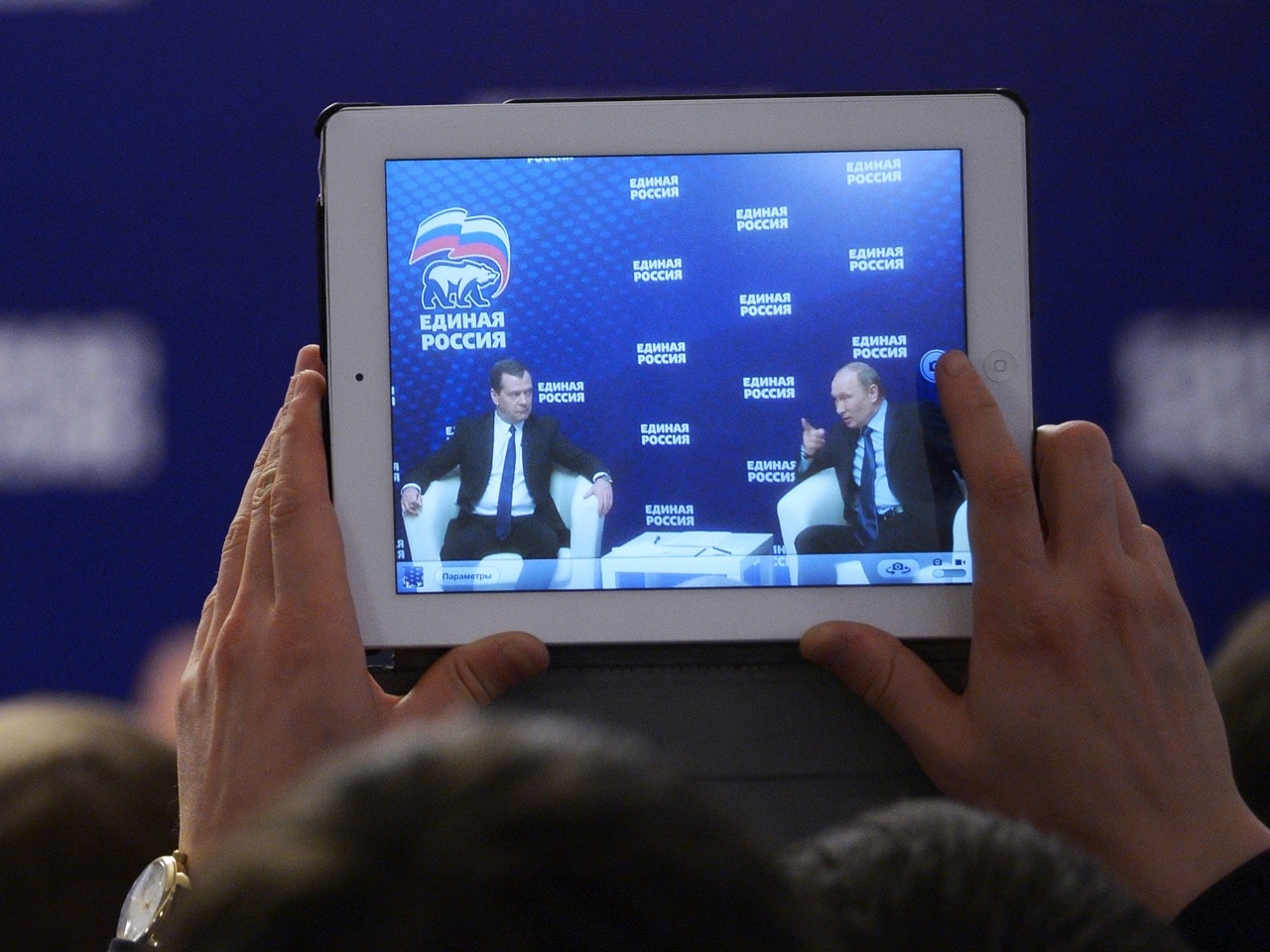 Russia's President Vladimir Putin (R) and Prime Minister Dmitry Medvedev are seen on a screen of a tablet computer, 3 October 2013, REUTERS/Alexander Astafyev/RIA Novosti/Pool