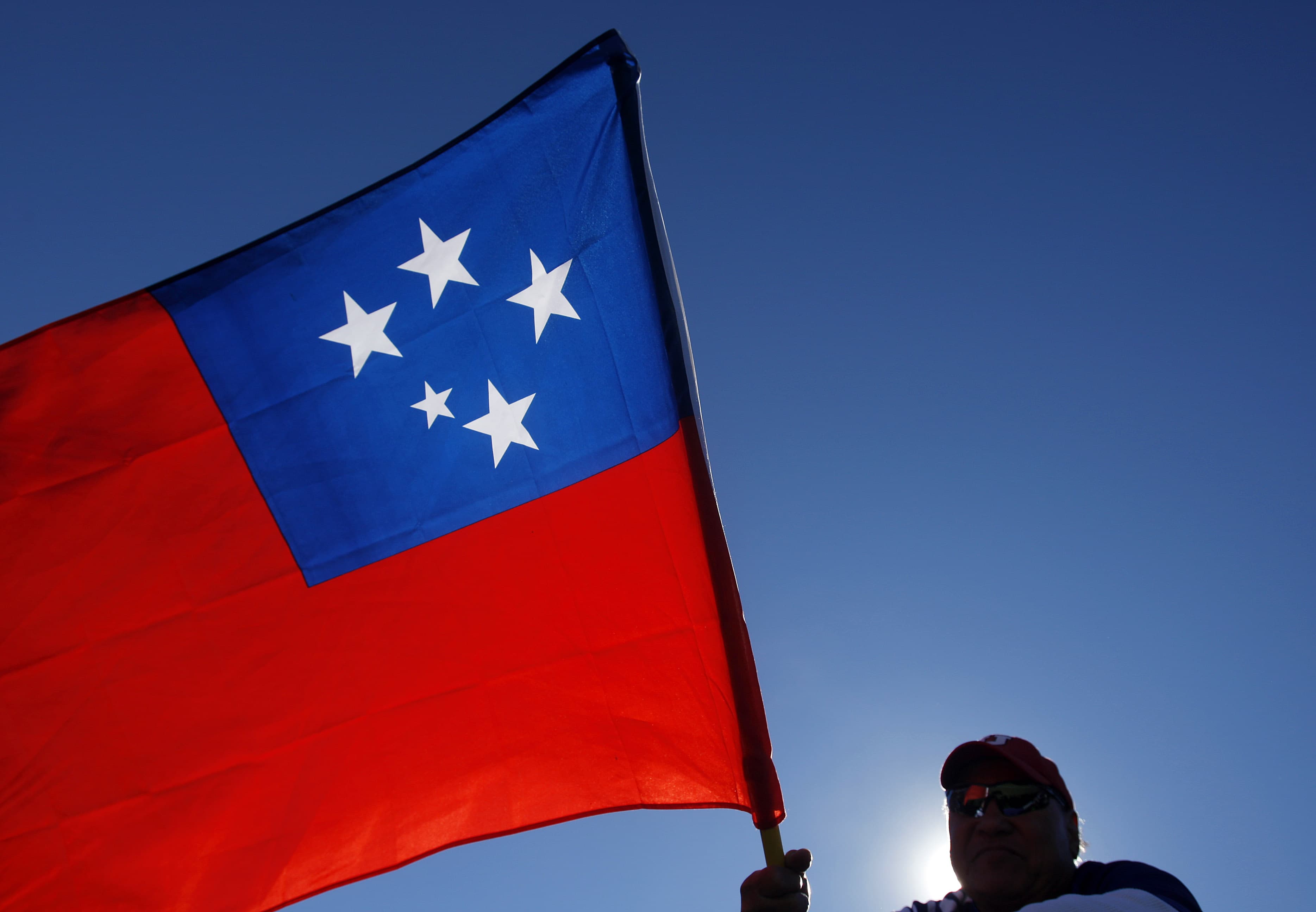 A fan waves the flag of Samoa during the USA Sevens International Rugby Championships, Las Vegas, 12 February 2011, Isaac Brekken/AP Images for USA Sevens