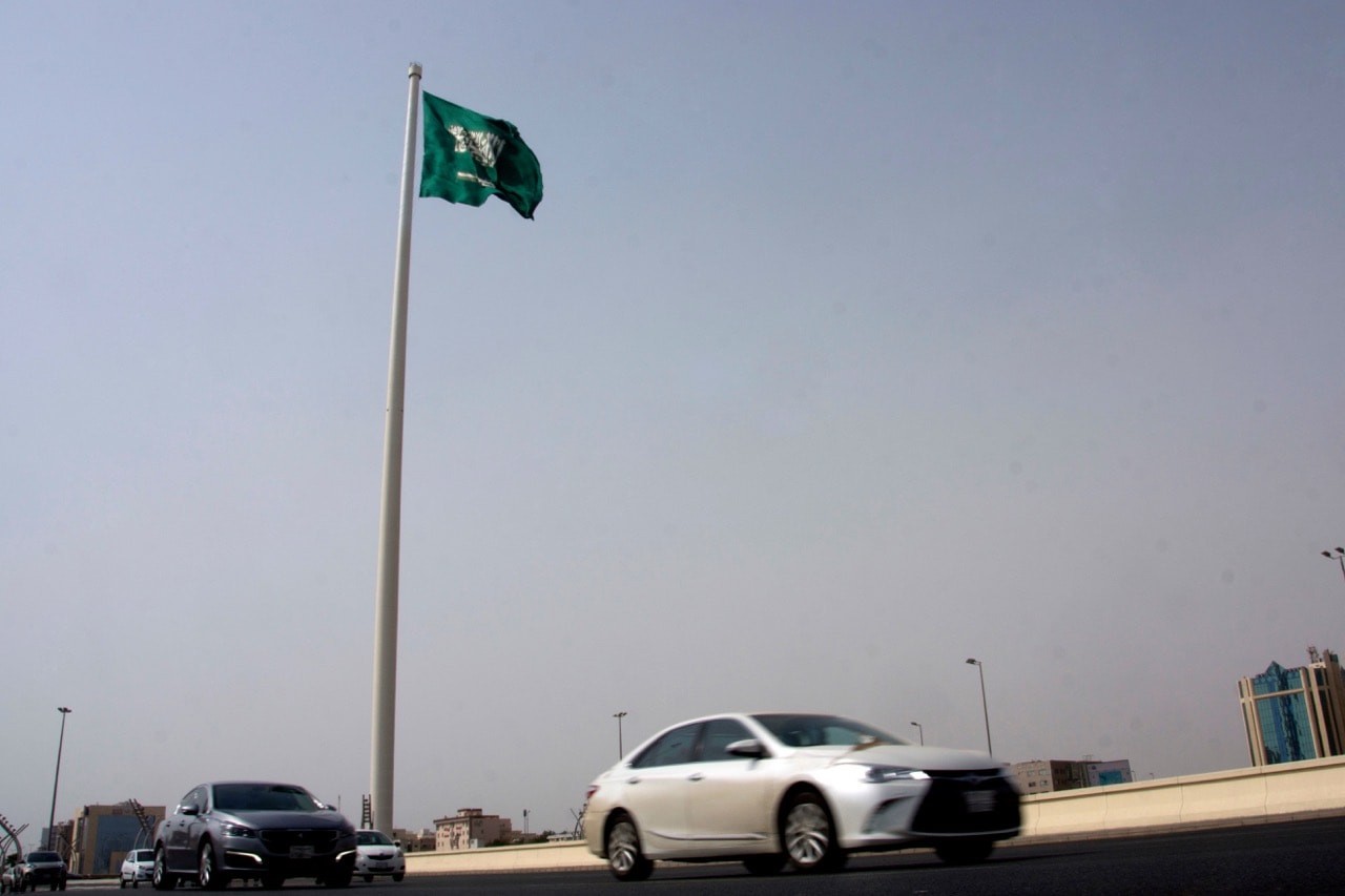 Vehicles pass under a Saudi flag in Jiddah, Saudi Arabia, 21 June 2017, AP Photo/Amr Nabil