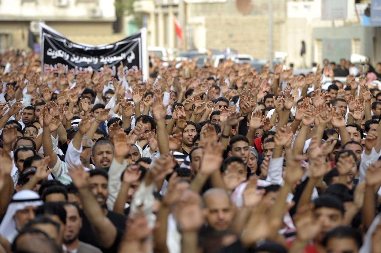 Saudi men chant slogans as they march in Kudeih, in the mainly Shiite coastal town of Qatif, 400 kms east of Riyadh, on 23 May 2015, to condemn the attack on a Shiite mosque, HUSSEIN RADWAN/AFP/Getty Images