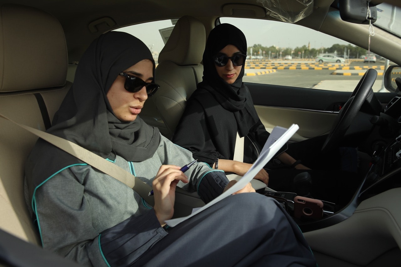 A student (R) and an instructor practice driving the day after women were once again permitted to drive in Saudi Arabia, in Jeddah, 25 June 2018, Sean Gallup/Getty Images