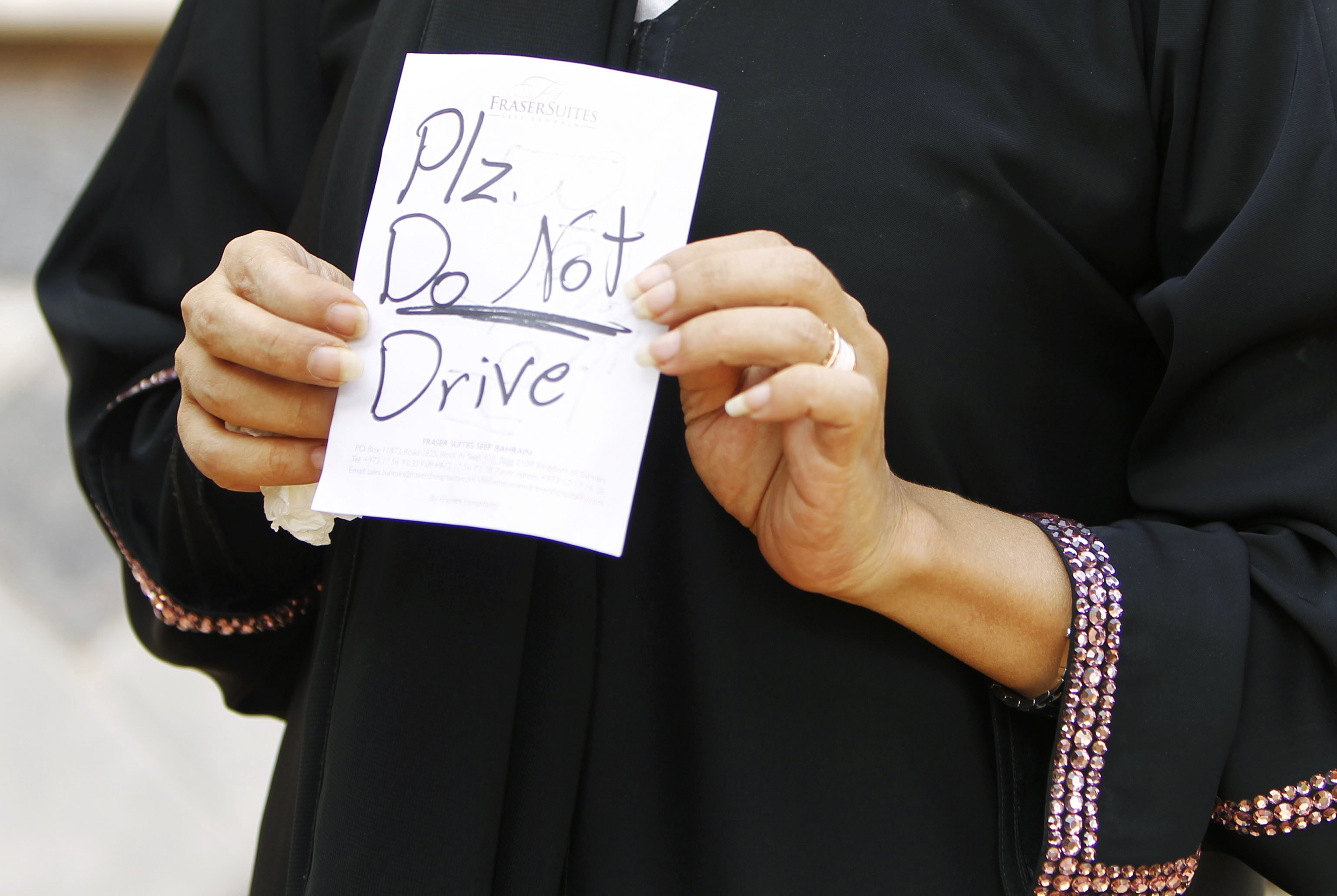 A Saudi Arabian writer has been arrested for supporting a campaign to lift the ban on women drivers in the country; in this June 2011 photo a female driver displays a note placed on her car by an unknown person, REUTERS/Fahad Shadeed