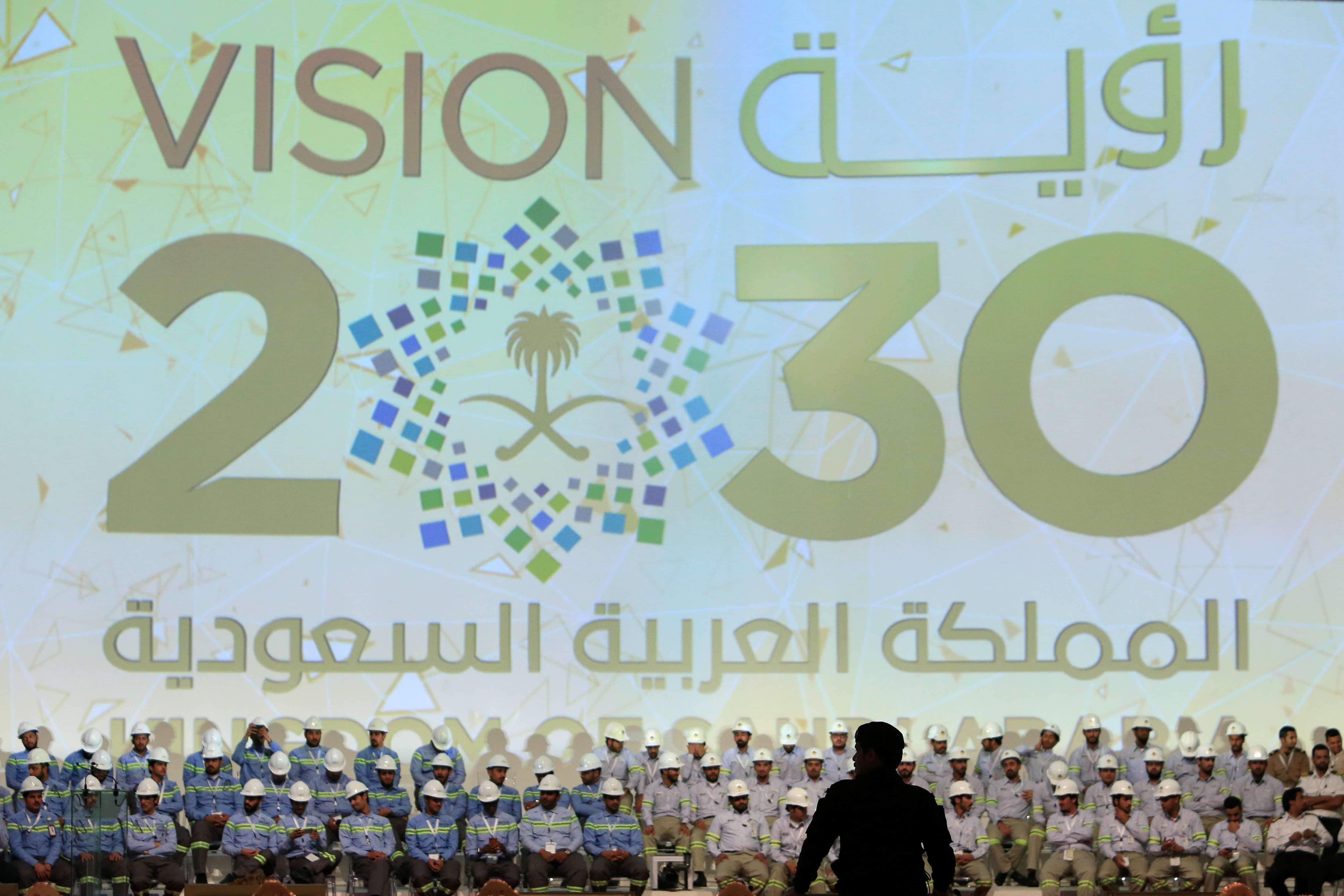 A large banner shows Saudi Vision for 2030 as a soldier stands guard before the arrival of Saudi King Salman at the inauguration of several energy projects in Ras Al Khair, Saudi Arabia, November 29, 2016., REUTERS/Zuhair Al-Traifi