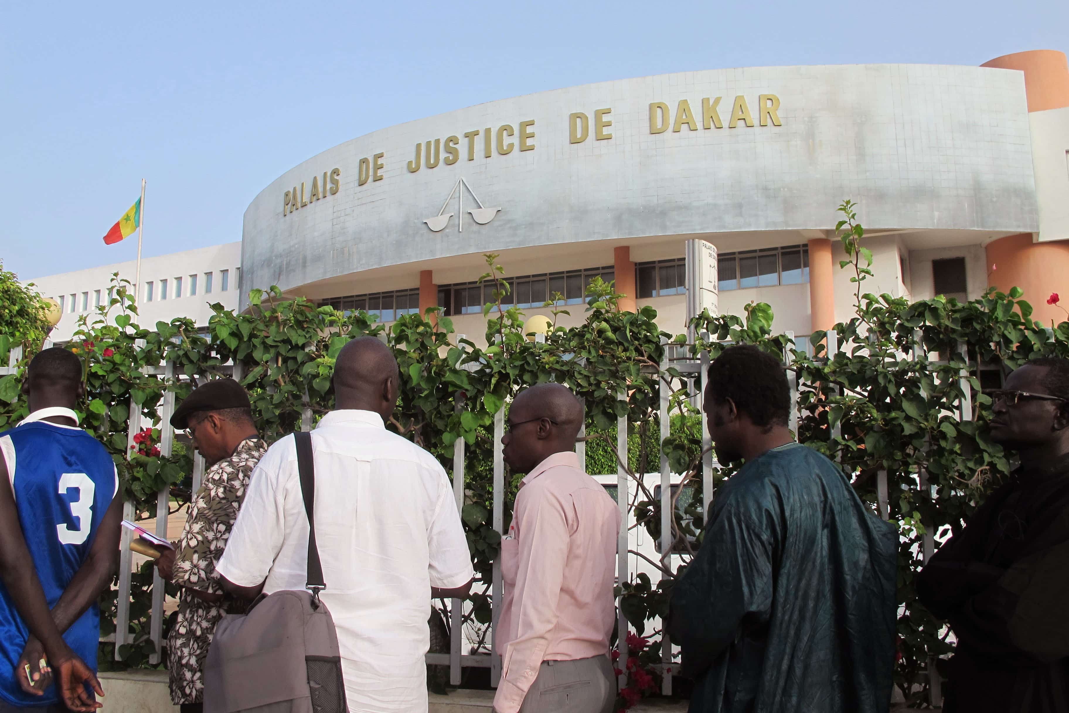 People stand in line before entering a court building in Dakar, Senegal, 20 July 2015, AP Photo/Carley Petesch