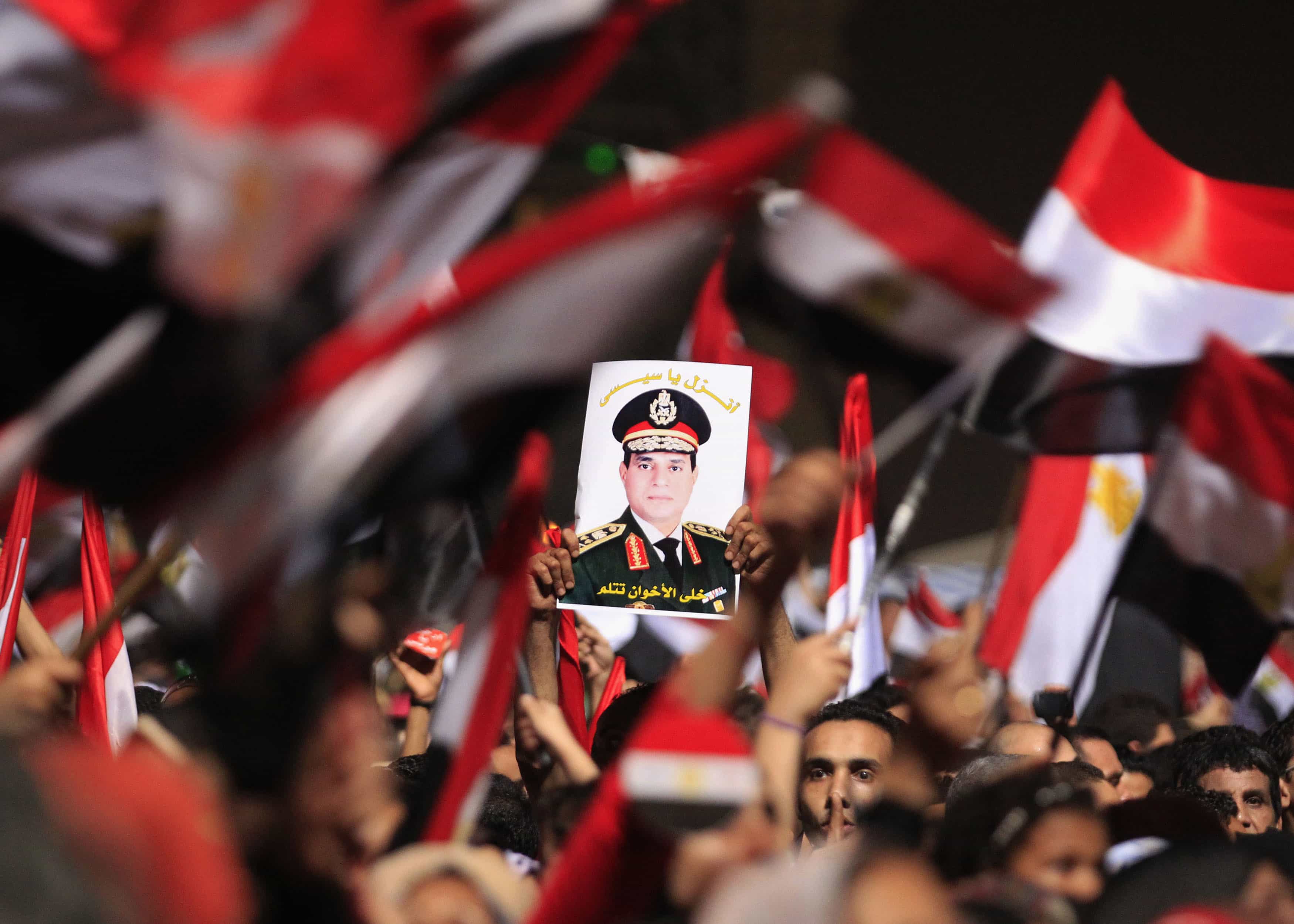 Protesters against deposed President Morsi hold a poster featuring the head of Egypt's armed forces General Abdel Fattah al-Sisi in Cairo on 3 July 2013, REUTERS/Mohamed Abd El Ghany