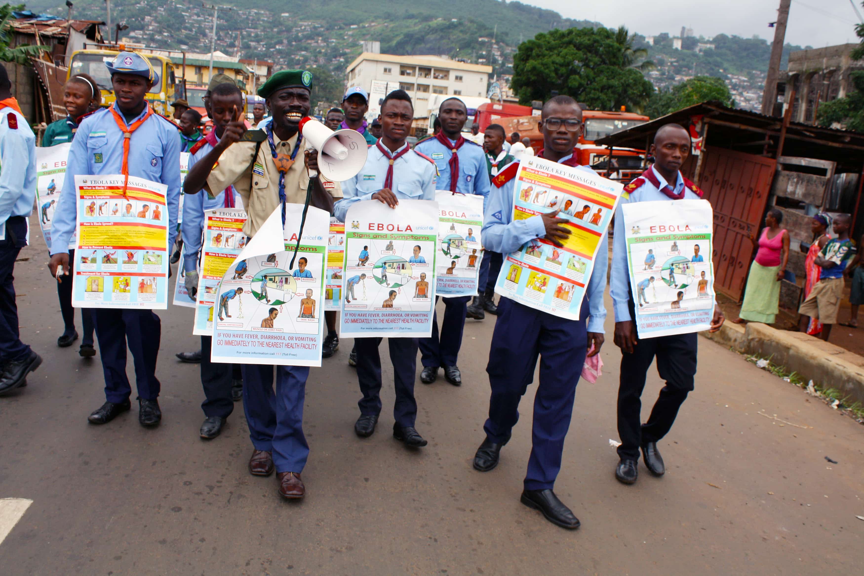 Members of a UNICEF-supported social mobilization team carry posters with information on Ebola, in Freetown, Sierra Leone, REUTERS/Issa Davies/UNICEF/Handout via Reuters