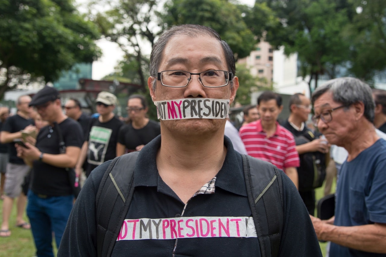 A man takes part in a protest against the "walkover" victory of Halimah Yacob as Singapore's President at Hong Lim Park in Singapore 16 September 2017, TOH TING WEI/AFP/Getty Images