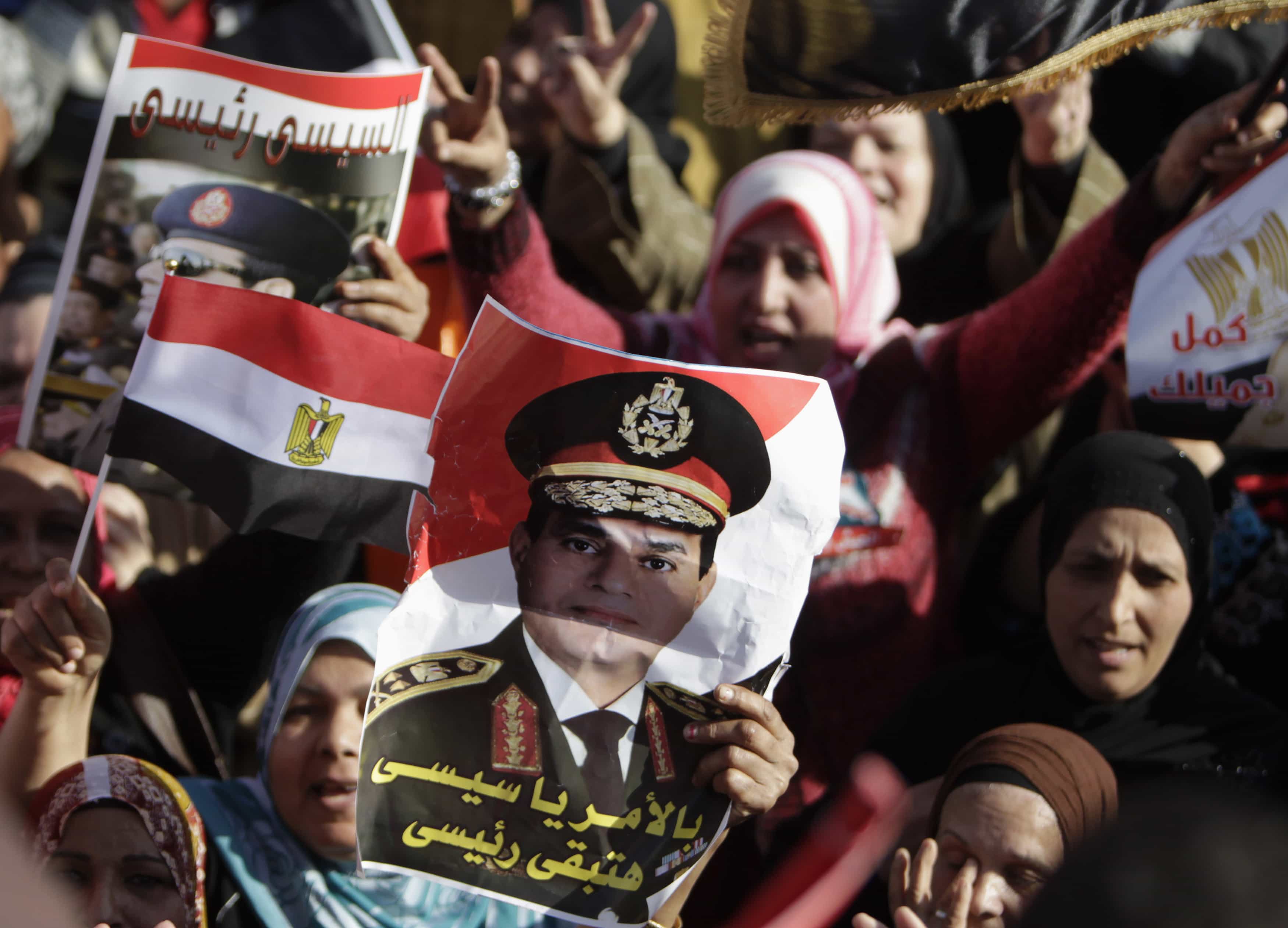 Egyptian demonstrators chanting for the army and police and raising flags and banners bearing images of General Abdel Fattah al-Sisi on 24 January 2014, REUTERS/ Mohamed Abd El Ghany