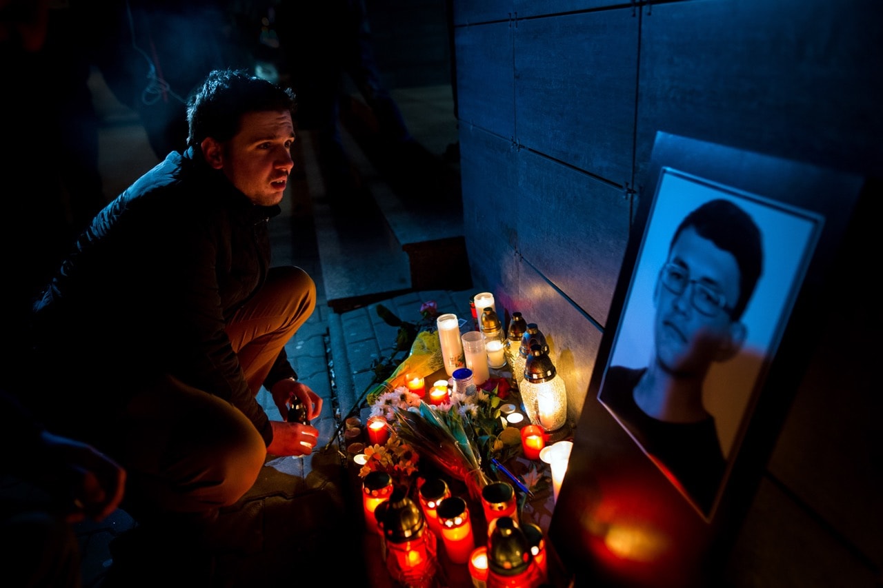 A man lights a candle in front of the Aktuality newsroom, the employer of the murdered investigative journalist Jan Kuciak, in Bratislava, Slovakia, 26 February 2018, VLADIMIR SIMICEK/AFP/Getty Images