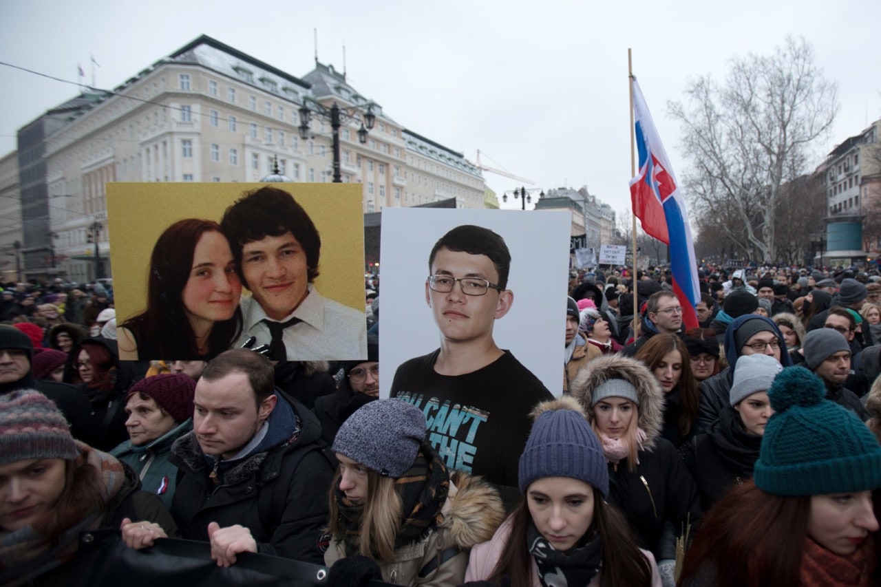 People hold portraits of murdered journalist Ján Kuciak and his fiancée Martina Kušnírová during a silent protest march in Bratislava, Slovakia, 2 March 2018, ALEX HALADA/AFP/Getty Images