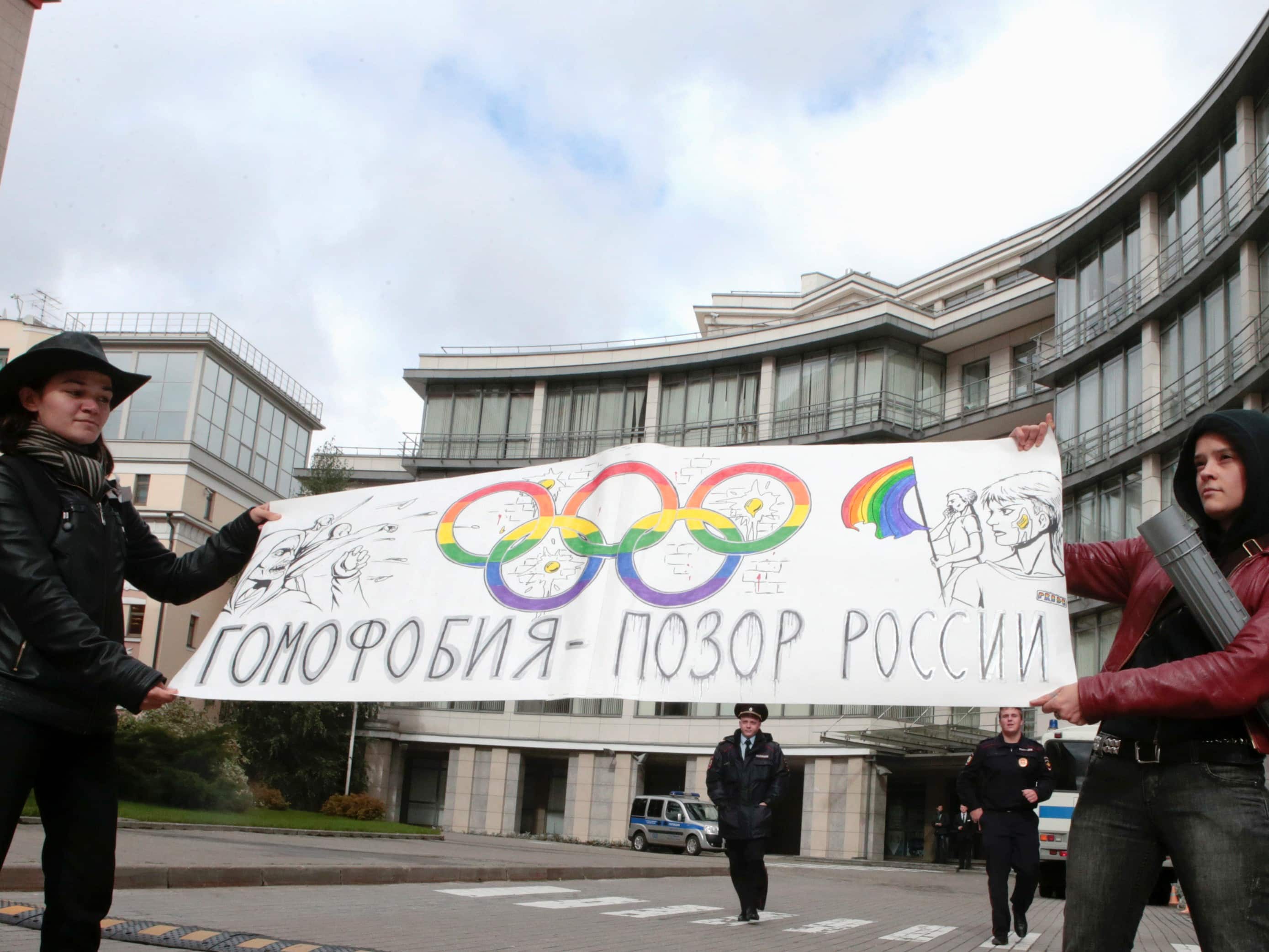 Gay rights activists hold a banner protesting a ban on gay pride parades during the Sochi 2014 Winter Olympics in Moscow in September., REUTERS/Tatyana Makeyeva