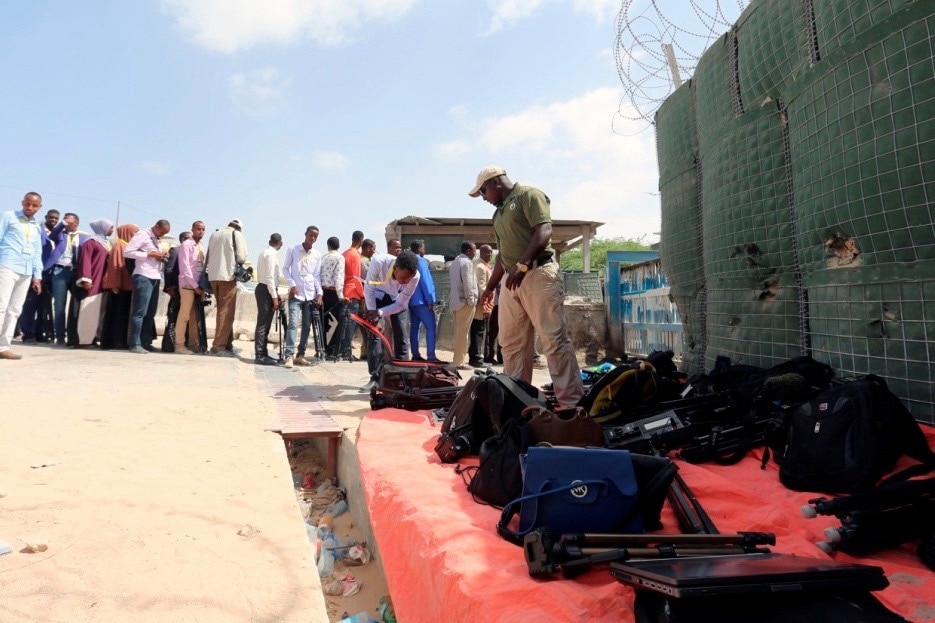 Journalists queue for a security sweep outside the venue of the presidential vote at the airport in Mogadishu, 8 February 2017, REUTERS/Feisal Omar