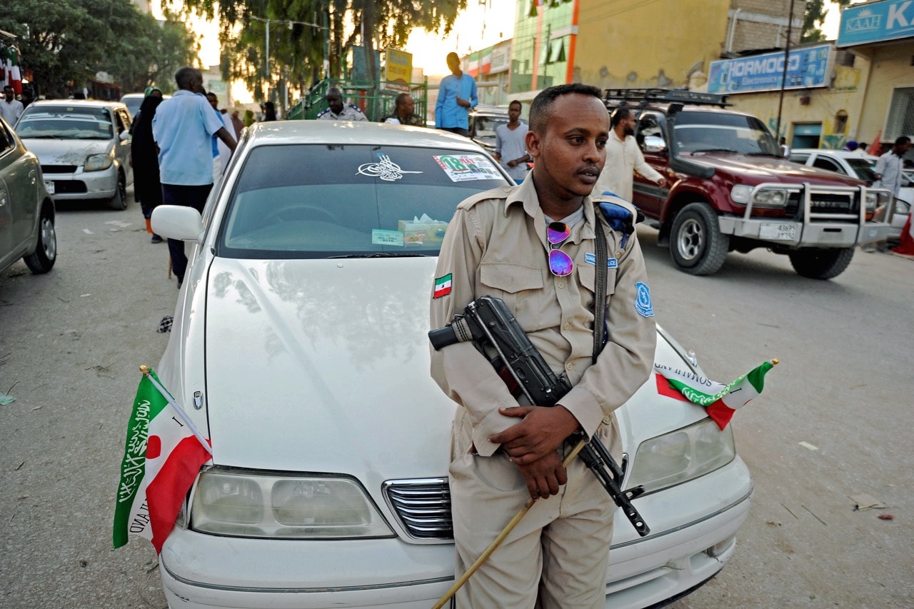 A policeman stands on a car in downtown Hargeisa, Somaliland, on 16 May 2016, MOHAMED ABDIWAHAB/AFP/Getty Images