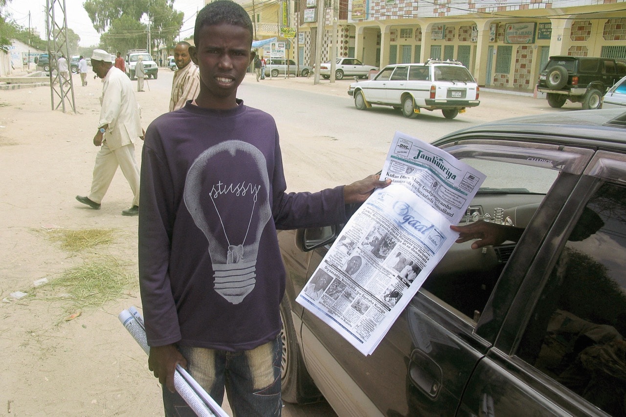 A newspaper street vendor Hassan approaches a car on a street in Hargeisa, Somaliland, 26 September 2005, ALI MUSA ABDI/AFP/Getty Images