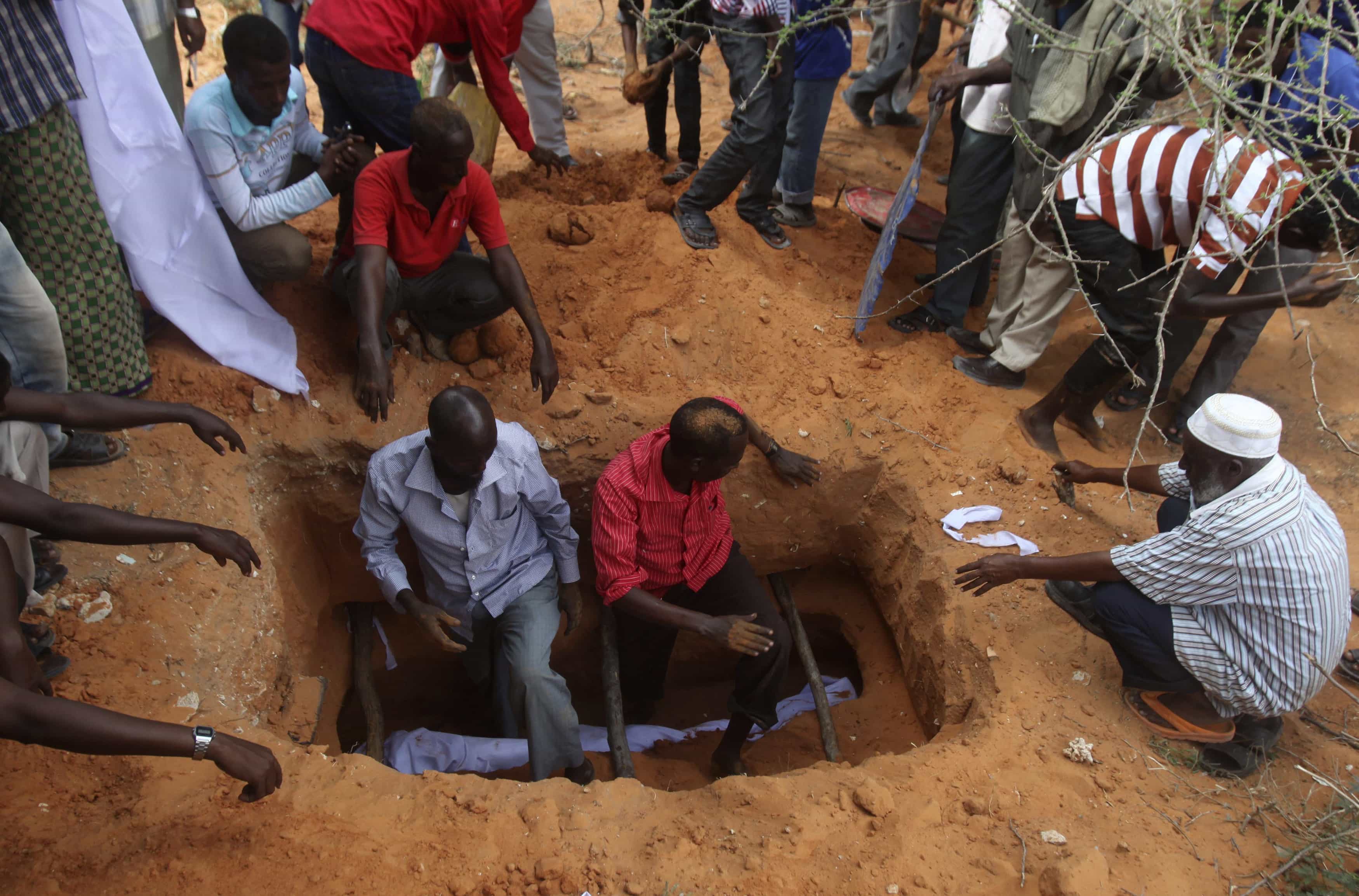 Somali residents bury the remains of Mohamed Nuxurkey, a local journalist who died during a car bomb explosion on 18 March 2013 in Mogadishu., REUTERS/Ismail Taxta