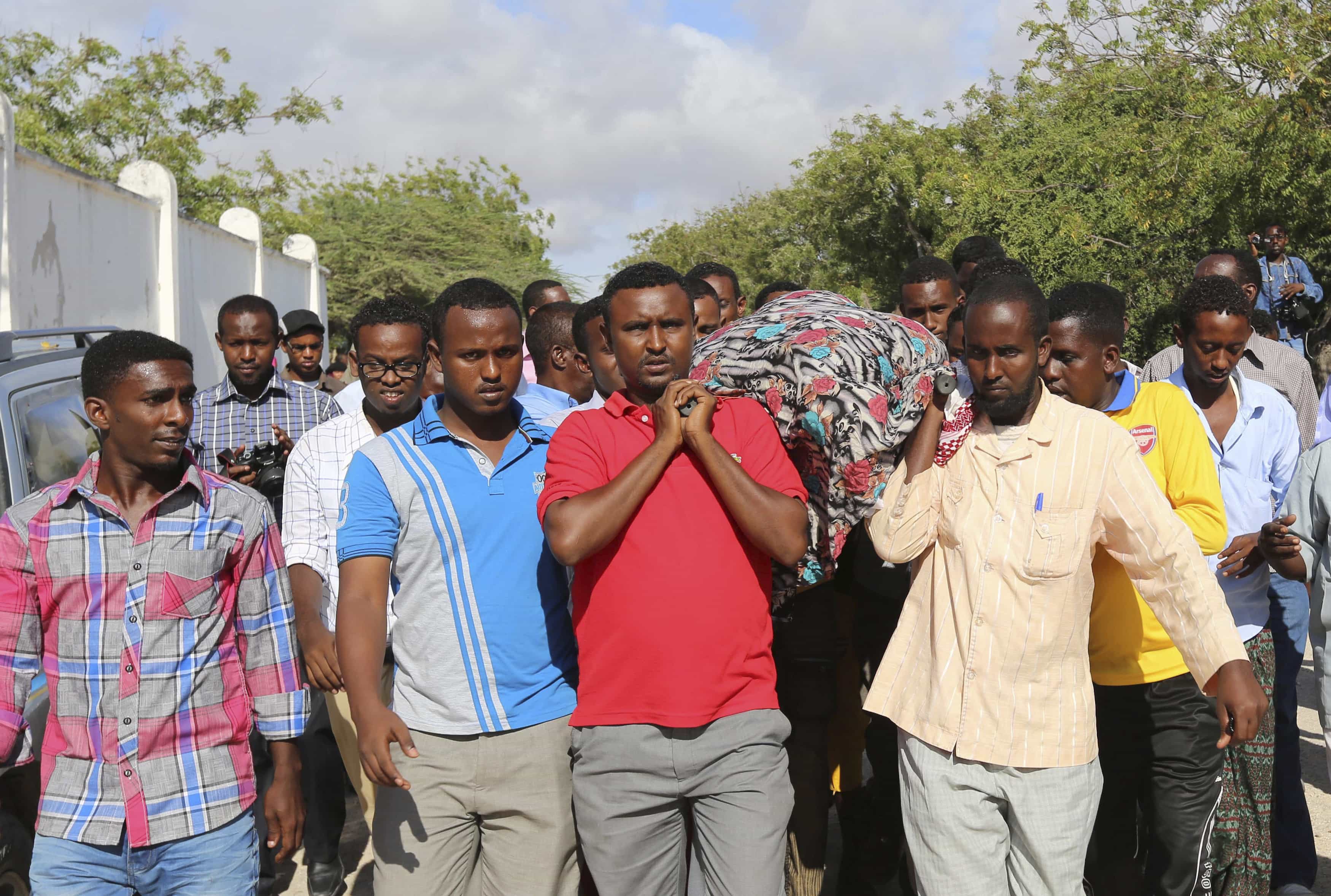 Friends and relatives carry the body of journalist Mohamed Mohamud Tima'ade, during his funeral in Mogadishu, 27 October 2013., REUTERS/Feisal Omar