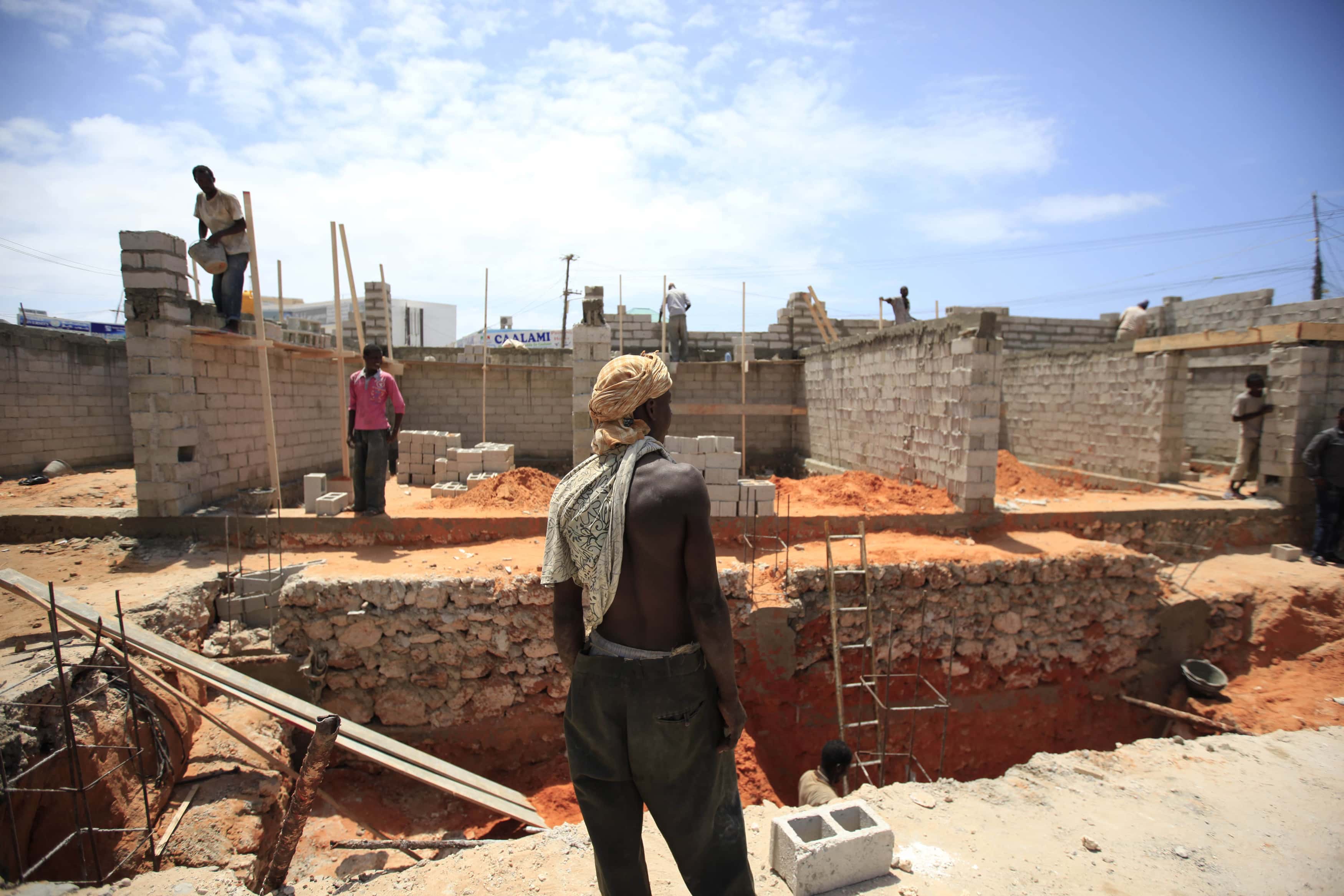 Labourers work at a petrol station construction site in Mogadishu, 24 September 2013., REUTERS/Omar Faruk