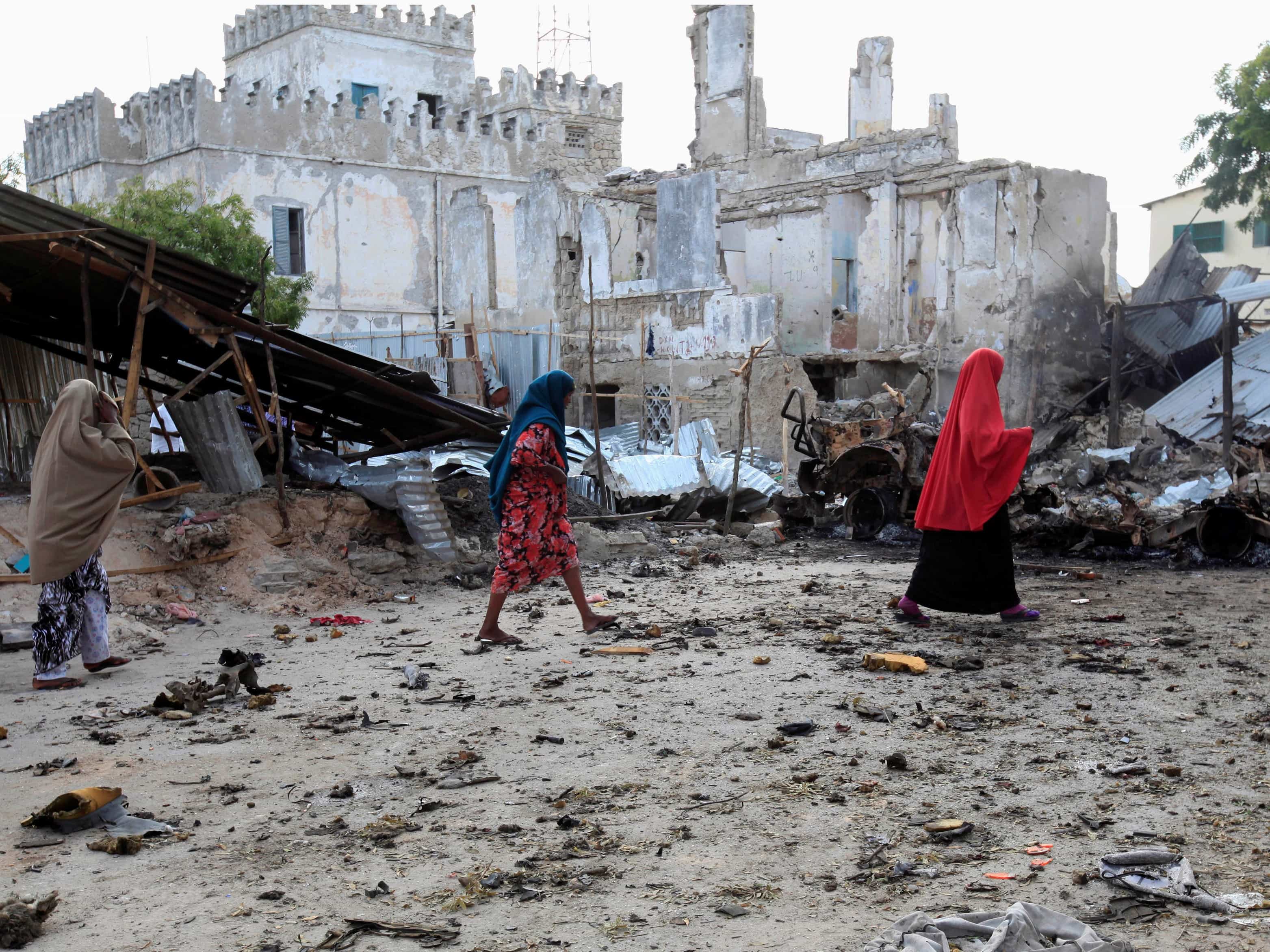Somali women walk past the site of a deadly blast in Mogadishu, 14 April 2013, REUTERS/Omar Faruk