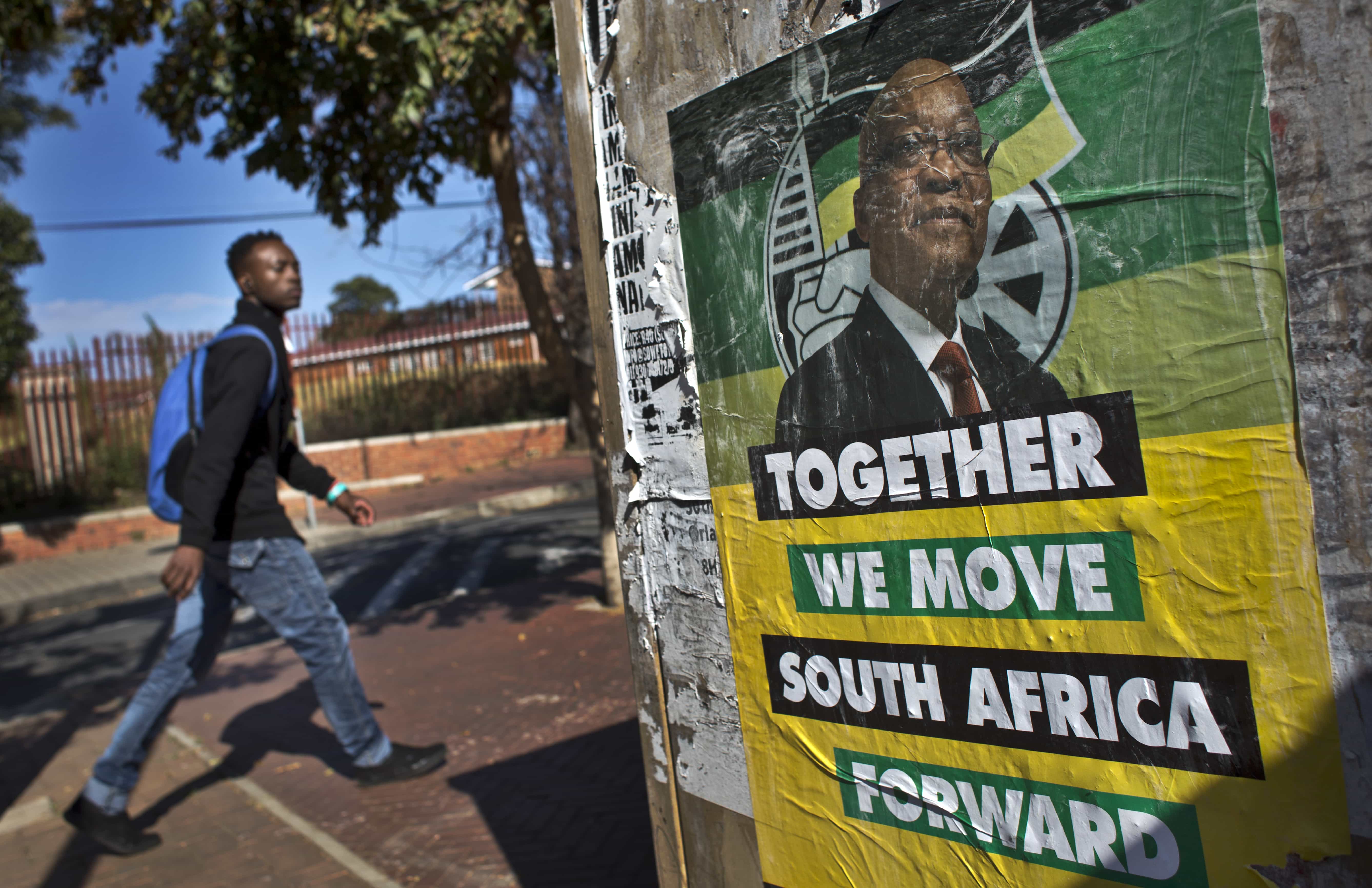 A man walks past an election poster of Jacob Zuma's African National Congress (ANC) party in the Soweto township of Johannesburg, 9 May 2014. , AP Photo/Ben Curtis