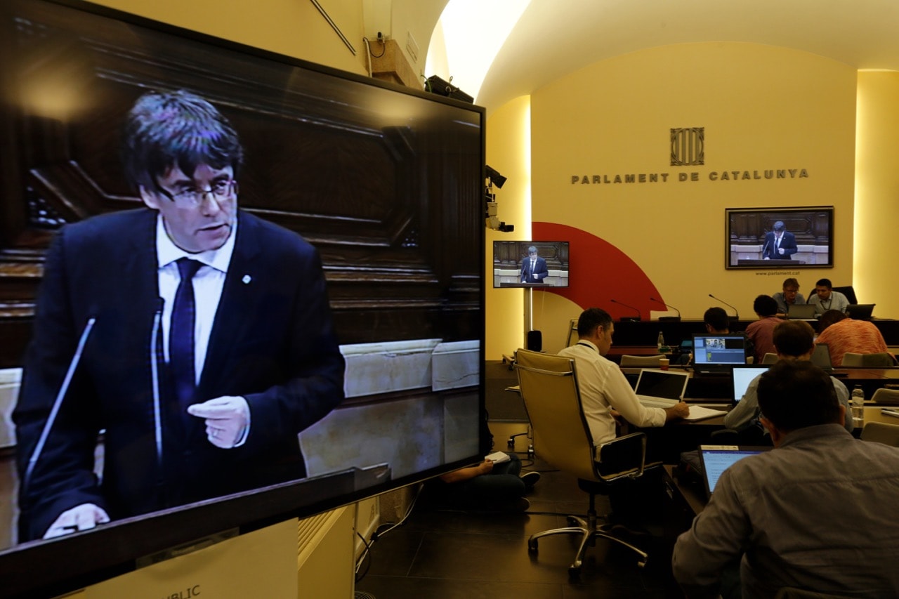 Journalists work in the press workroom as now deposed Catalan President Carles Puigdemont addresses the Catalan parliament in Barcelona, Spain, 10 October 2017 , AP Photo/Emilio Morenatti