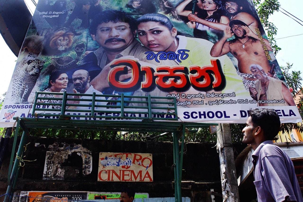 A pedestrian walks past a billboard advertising a local film in the suburb of Nugegoda in Colombo, Sri Lanka, 6 May 2007, SANKA VIDANAGAMA/AFP/Getty Images