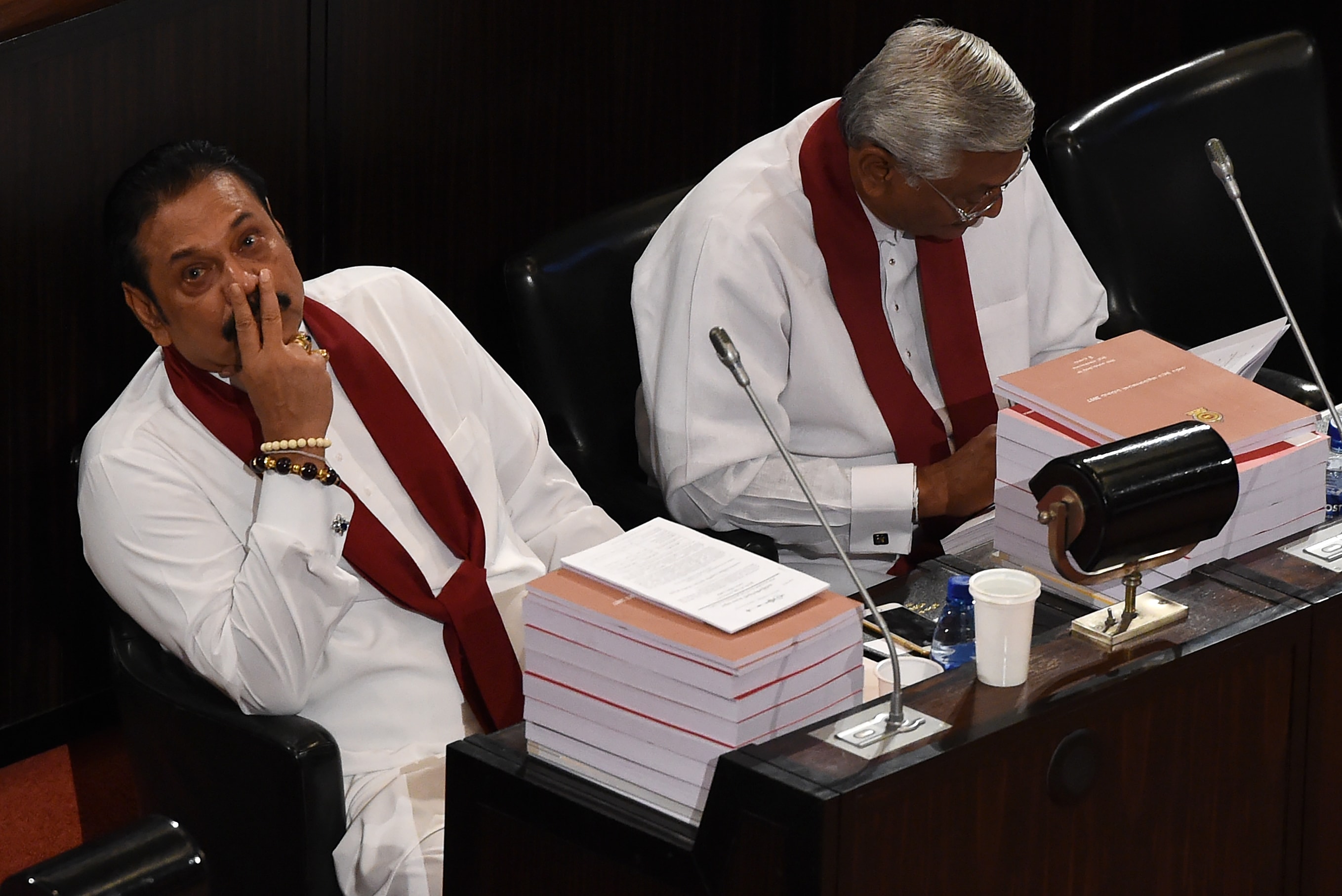 Former Sri Lankan president Mahinda Rajapaksa (L) listens as Finance Minister Ravi Karunanayake (unseen) presents the 2017 budget to the parliament in Colombo, 10 November 2016, ISHARA S.KODIKARA/AFP/Getty Images