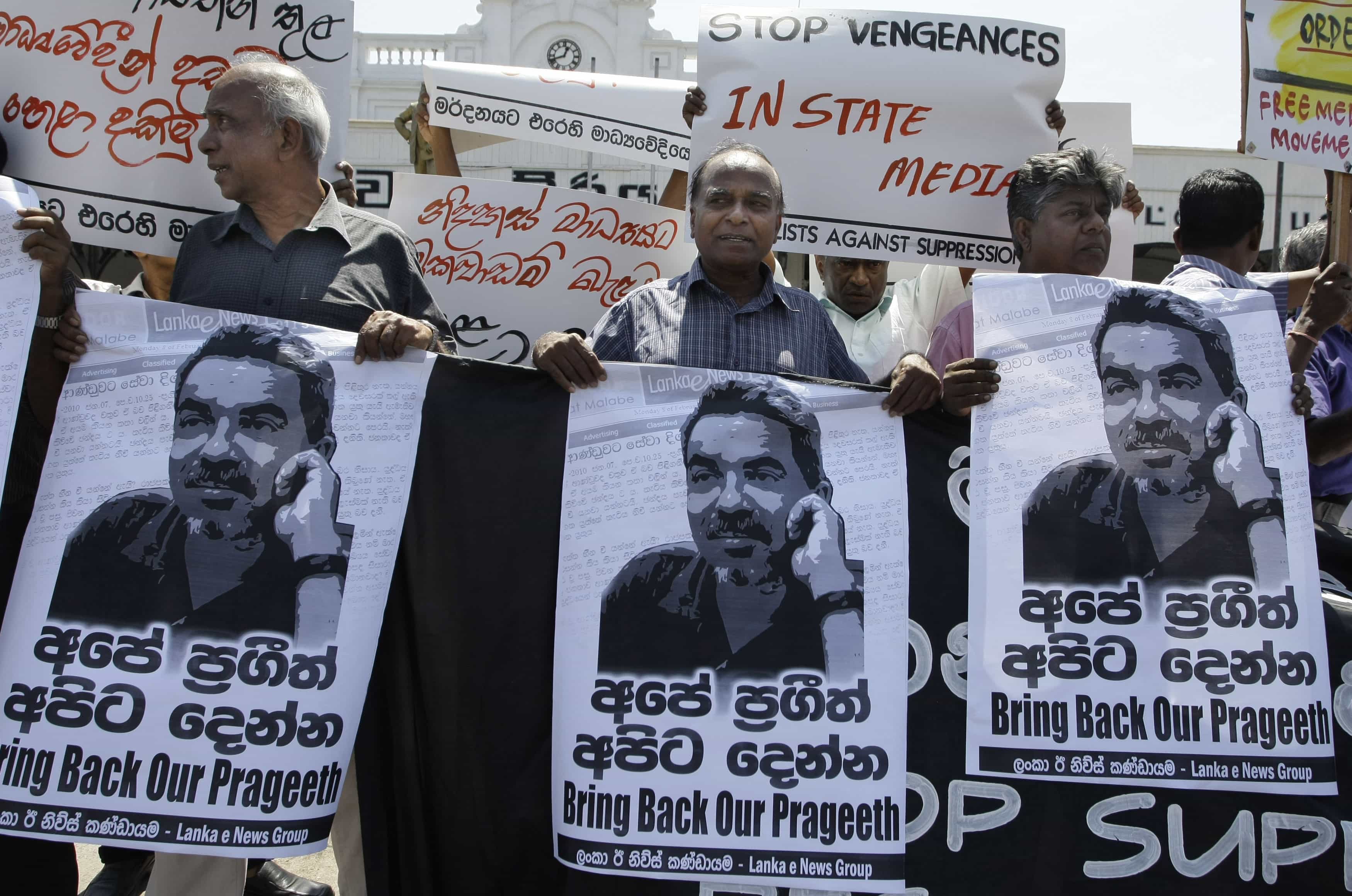 In this 8 February 2010 file photo, Sri Lankan media rights activists hold posters of Prageeth Eknaligoda during a protest in Colombo, AP Photo/Eranga Jayawardena