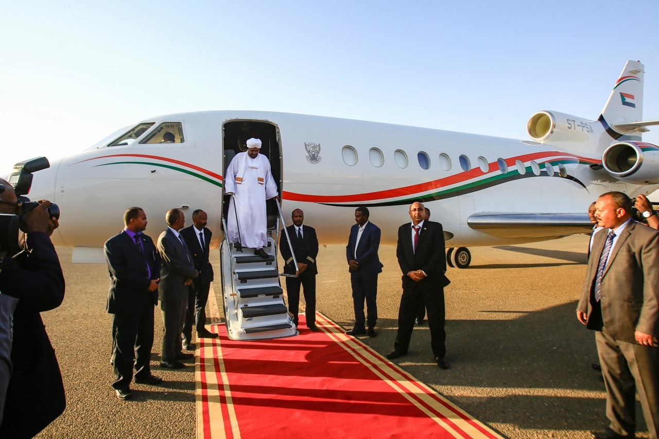 Sudan's President Omar al-Bashir disembarks from his jet upon arrival at Khartoum International Airport, returning from Qatar, 23 January 2019, ASHRAF SHAZLY/AFP/Getty Images