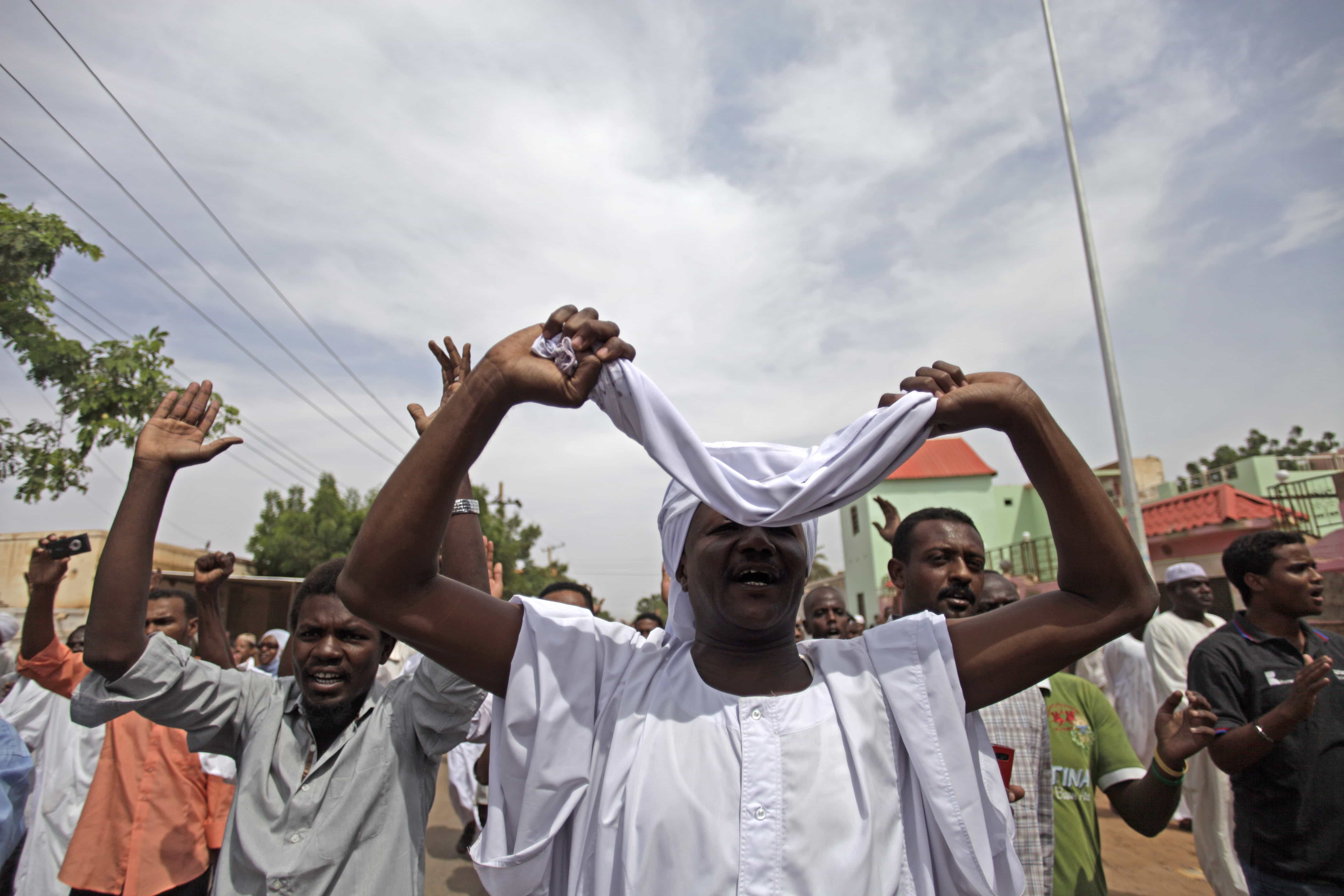 Sudanese anti-government protesters chant slogans after the Friday noon prayer in the Omdurman district of northern Khartoum, 27 September 2013., AP Photo/Khalil Hamra, File