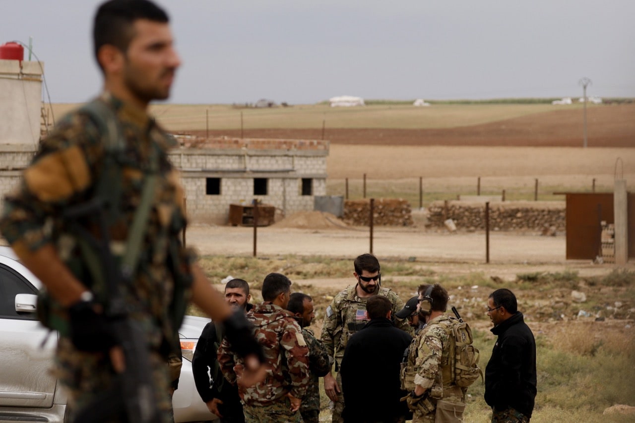 US forces and members of the Syrian Democratic Forces (SDF) patrol the Kurdish-held town of Al-Darbasiyah in northeastern Syria bordering Turkey, 4 November 2018, DELIL SOULEIMAN/AFP/Getty Images