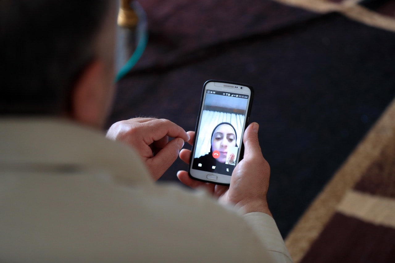 A Syrian man and his family who have found refuge in Bloomfield Township, MI, speak to their daughter in Turkey using WhatsApp video chat, 29 January 2017, Fabrizio Costantini for the "Washington Post"
