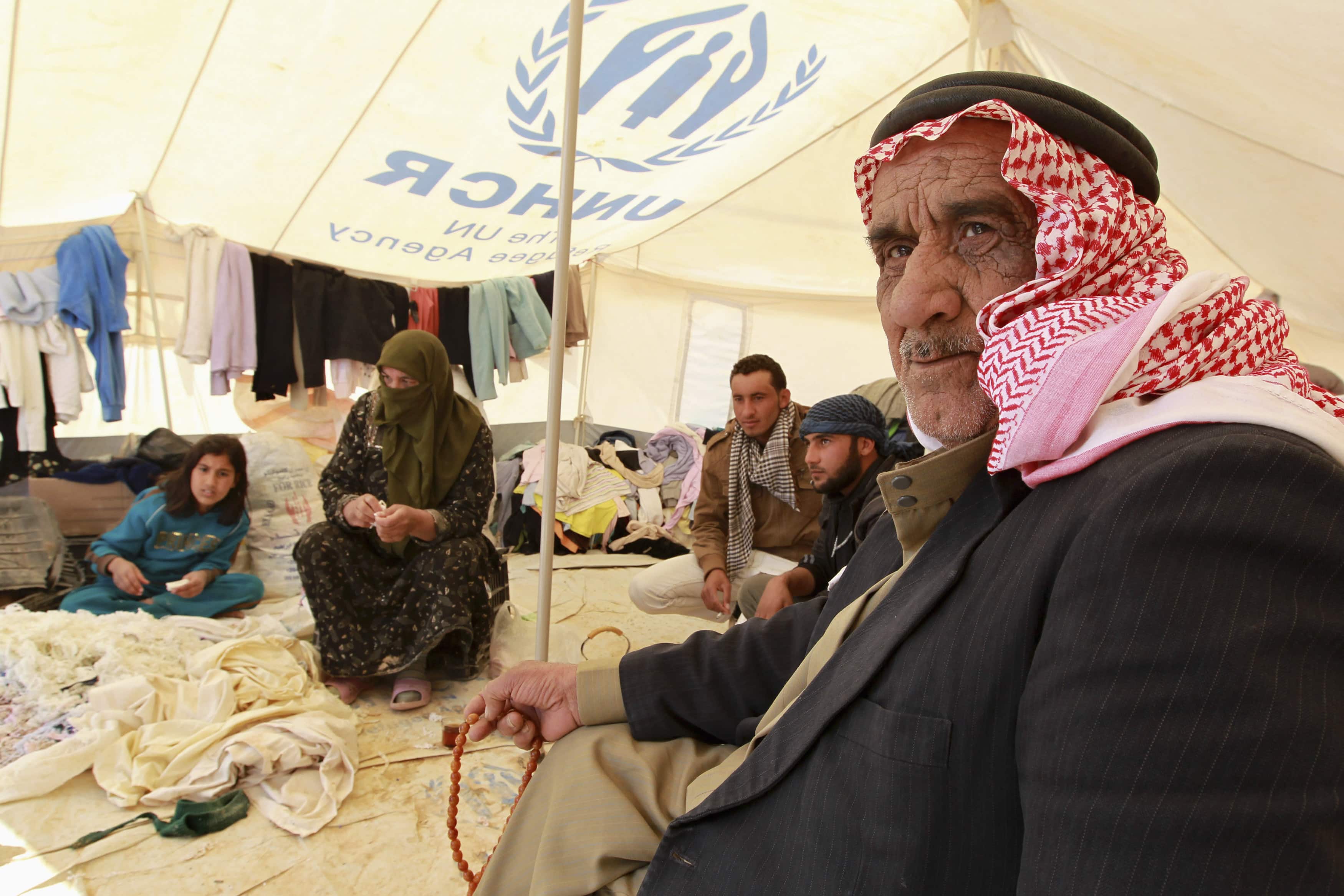 Syrian refugees sit in a second hand clothes shop at Al Zaatri refugee camp in the Jordanian city of Mafraq, near the border with Syria, REUTERS/Muhammad Hamed