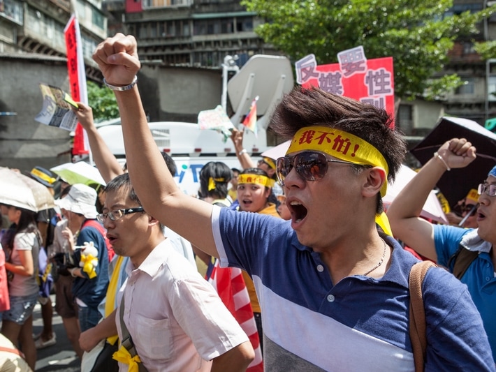 Activists and civic groups march in Taipei in protest against the Want Want China Times Group's planned acquisition of China Network Systems' cable TV services in September 2012, Craig Ferguson/Demotix