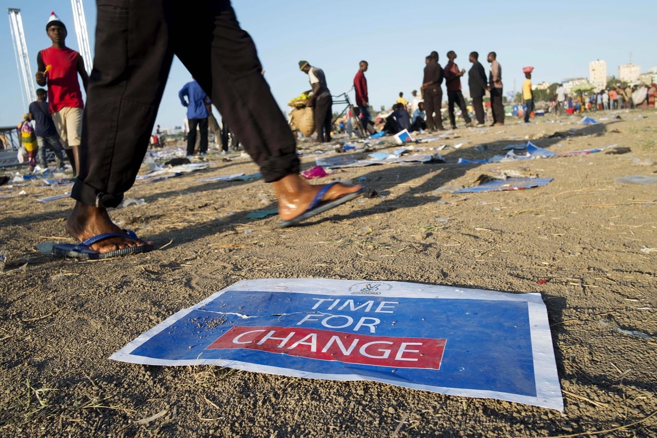 A poster reading 'Time for change' lies on the ground after a campaign rally by an opposition party, in Dar es Salaam, Tanzania, 24 October 2015, Daniel Hayduk/AFP/Getty Images