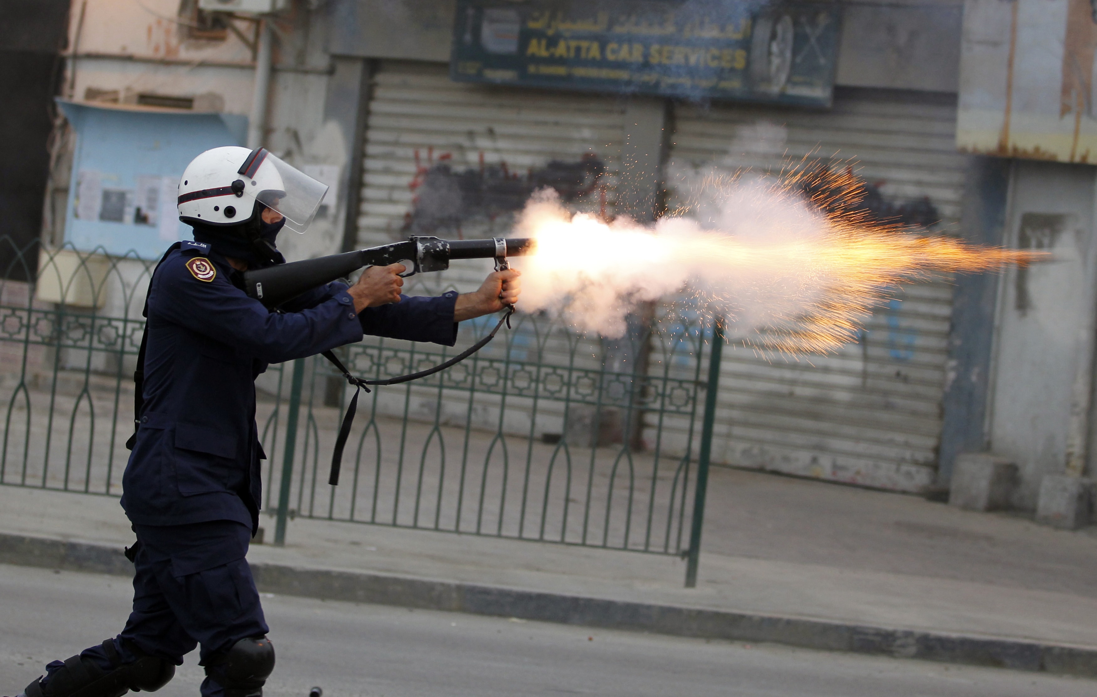 A riot police officer fires teargas during clashes with protesters after a rally held in support of opposition members serving life in prison in Bahrain on 1 April 2012, REUTERS/Hamad I Mohammed