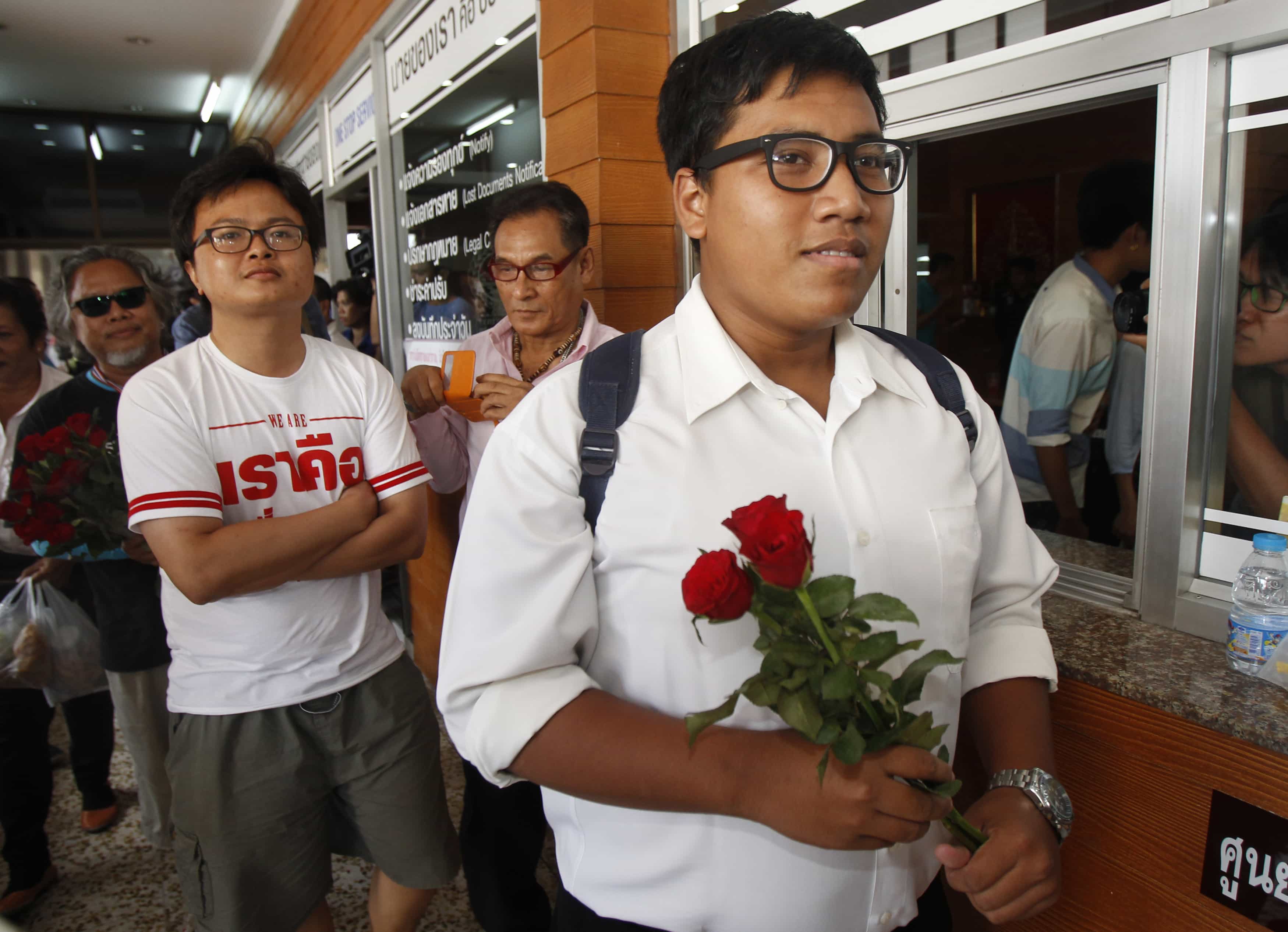 Arnon Numpa (2nd L), a 30-year-old rights lawyer, and Sirawith Seritiwat (R), 24, a student, leaves a police station for the military court in Bangkok March 16, 2015, REUTERS/Chaiwat Subprasom