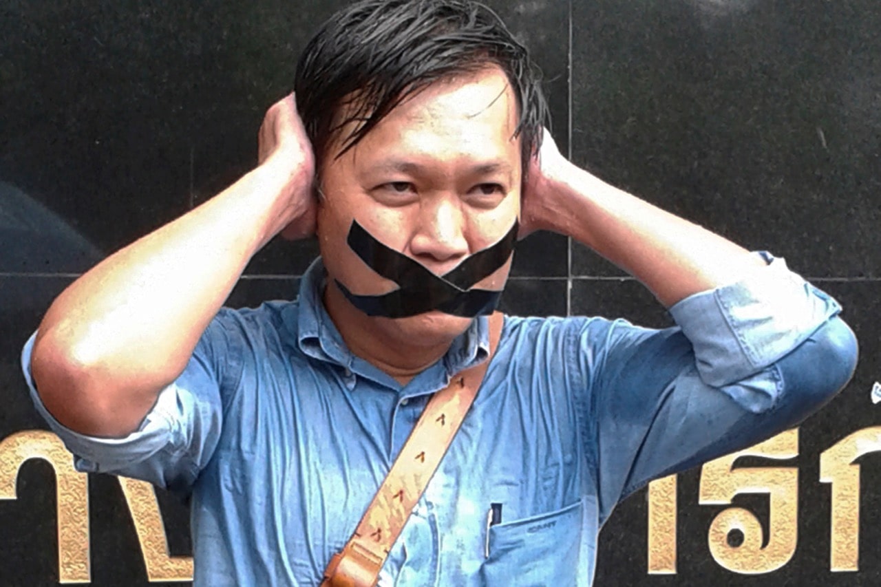 Thai columnist Pravit Rojanaphruk poses for a photograph while being called to report to the ruling military along with other journalists in Bangkok, 25 May 2014, AP Photo