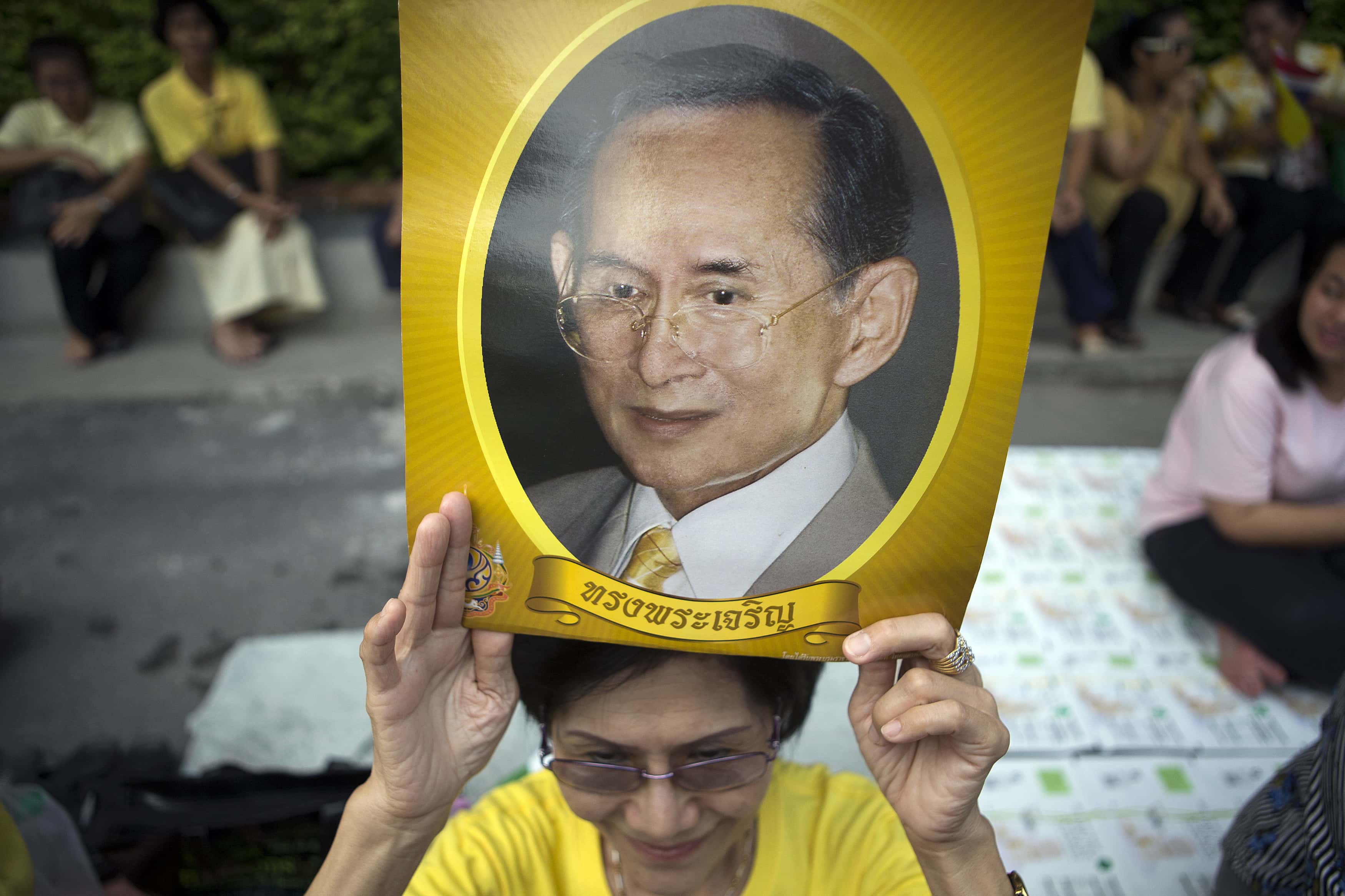 Editor Nut Rungwong has been convicted of defaming King Bhumibol Adulyadej, pictured in this image held by one of his supporters, in Bangkok, 15 September 2014, REUTERS/Athit Perawongmetha