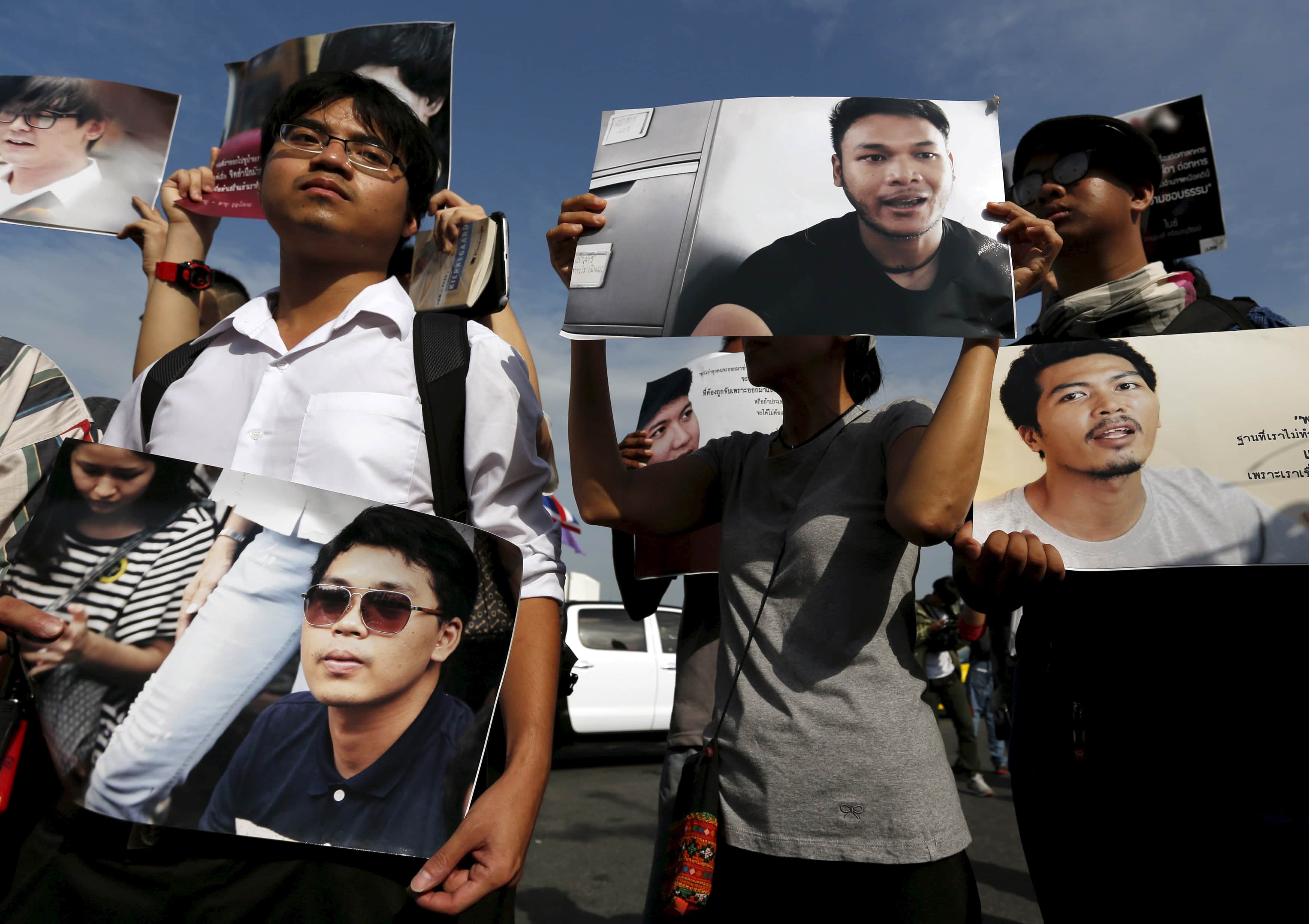 Members of the New Democracy Movement activist group and supporters hold up pictures of the 14 students who had been held for holding anti-coup protests, during a rally outside the military court in Bangkok, 7 July 2015, REUTERS/Chaiwat Subprasom