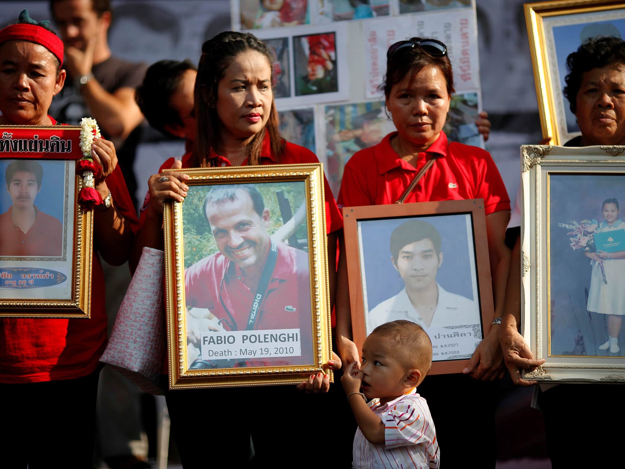 On 19 May 2011, anti-government ''red shirt'' protesters hold pictures of killed friends and relatives and killed Italian photographer Fabio Polenghi during a rally in Bangkok to mark the one-year anniversary of the violence, REUTERS/Damir Sagolj