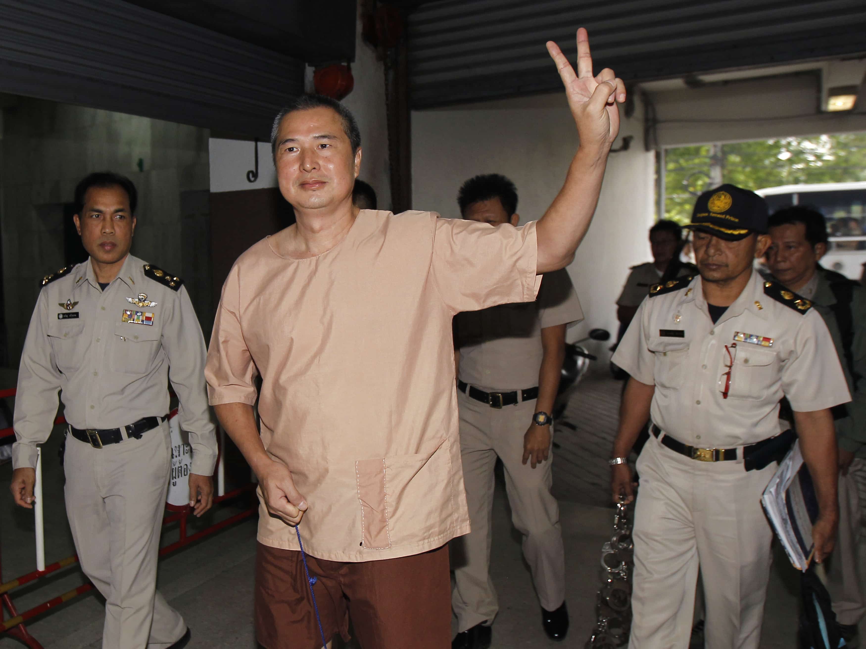 Editor Somyot Pruekasemsuk gestures as he arrives at the criminal court in Bangkok, 23 January 2013, REUTERS/Chaiwat Subprasom